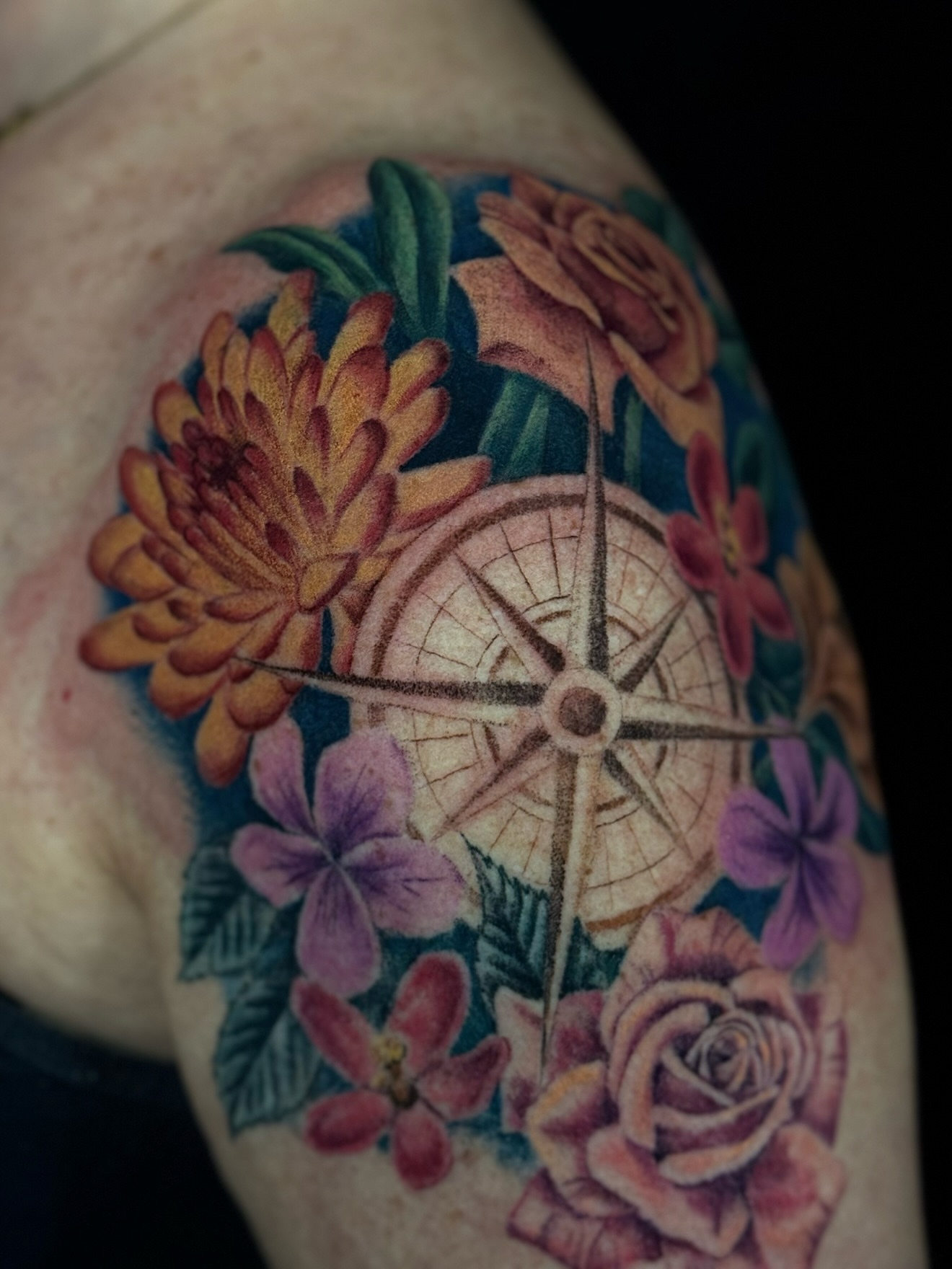 Compass and floral arrangement realism tattoo on the shoulder by Alyssa Fazzino ⟡ CT Tattoo Artist, Rocky Hill, Connecticut
