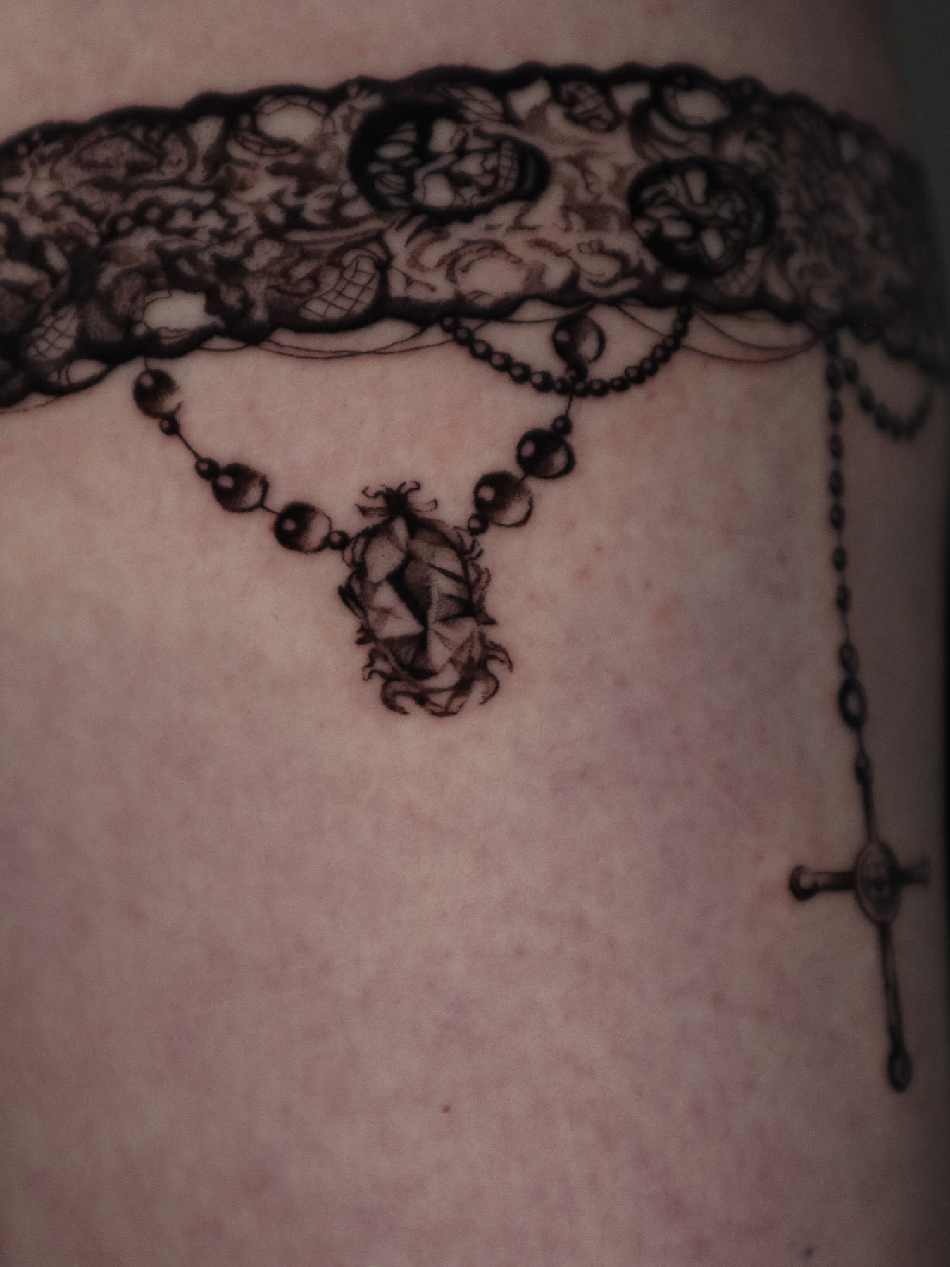Lace and rosary black and grey tattoo on the torso by 𝕮𝖔𝖓𝖓𝖔𝖗 ☾  ~ TATTOO ARTIST