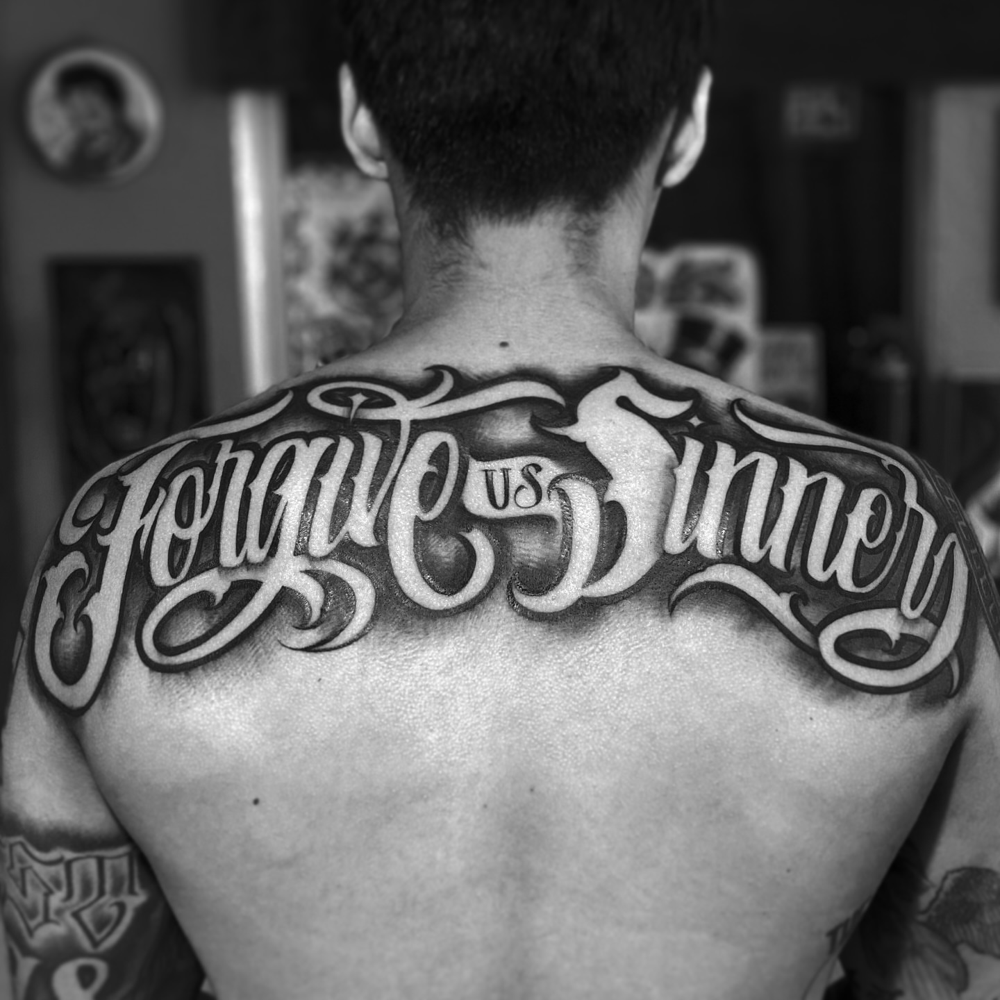 Forgive us sinners lettering script tattoo on the back by Lex Miranda