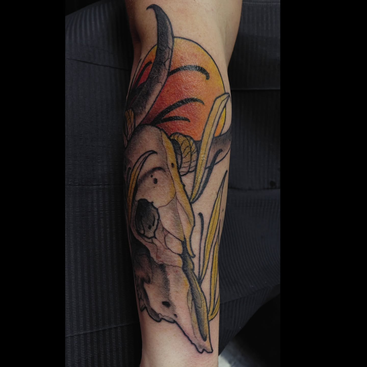 Skull and flowers American traditional tattoo on the forearm by Ben Friday, Phoenix, Arizona