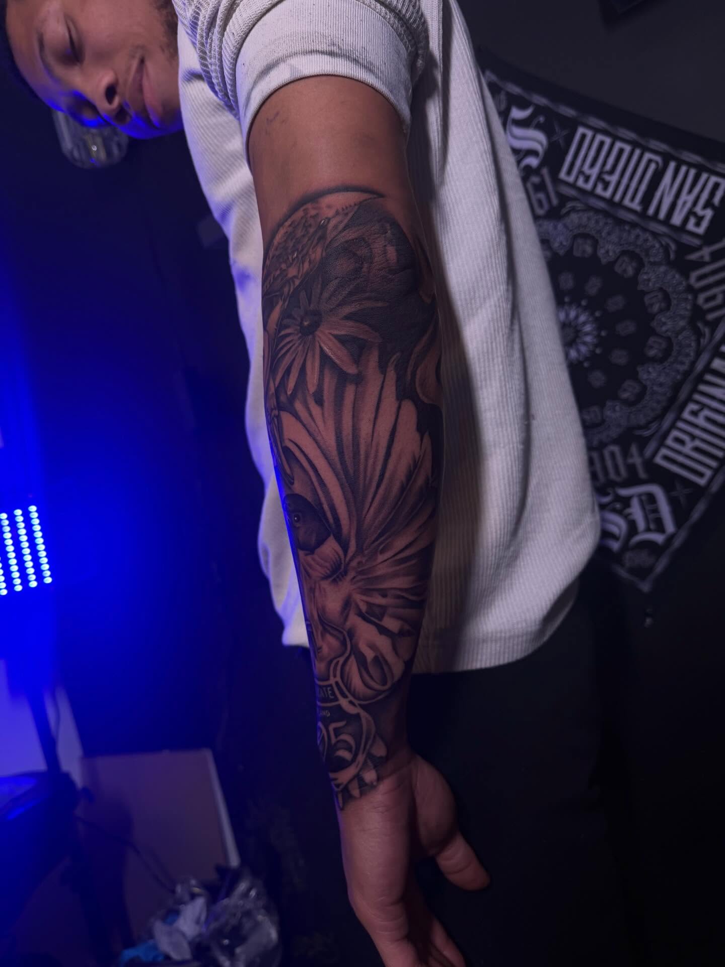 Floral design black and grey tattoo on the forearm by San Diego Tattoo Artist