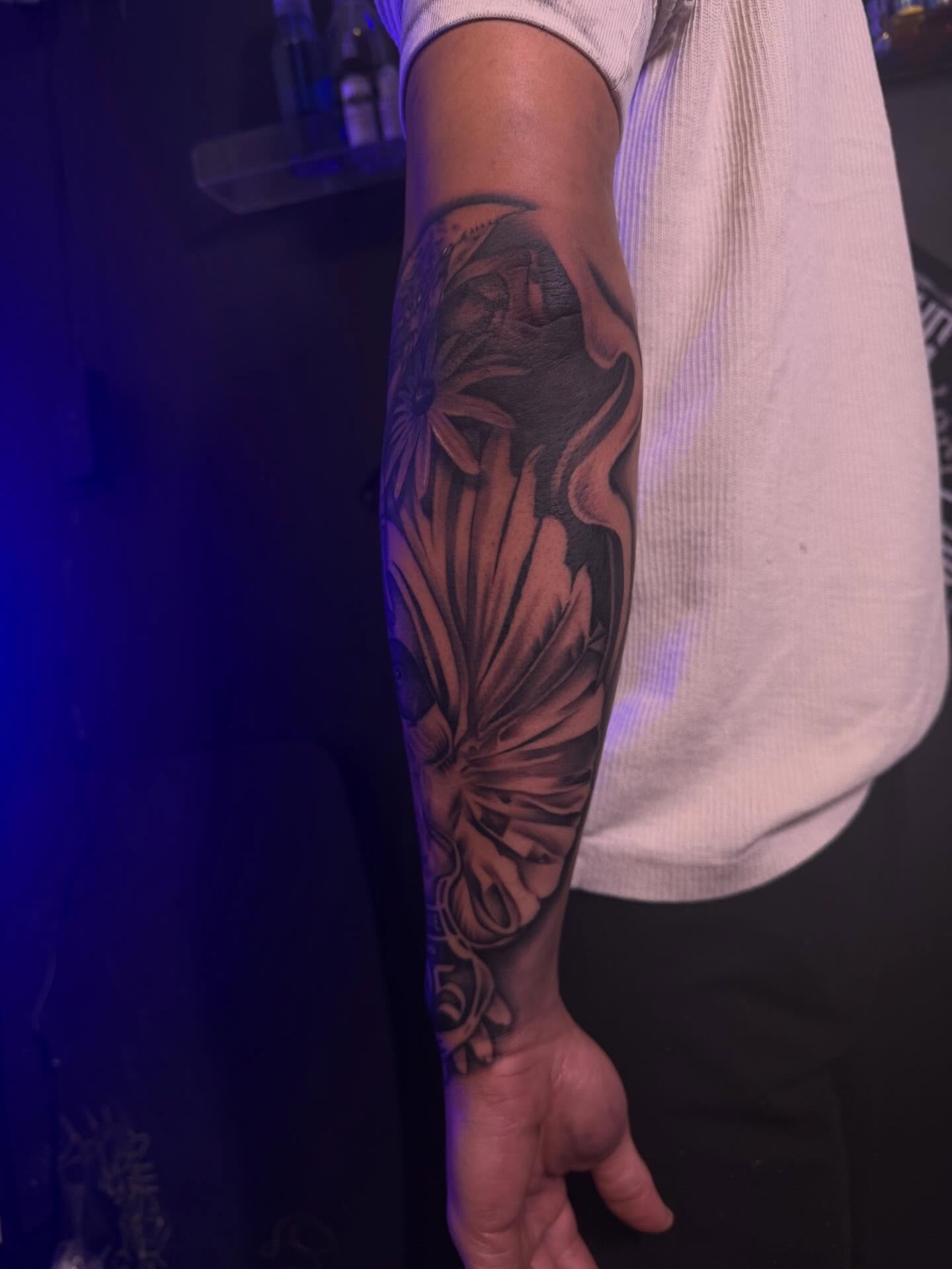 Floral design realism tattoo on the forearm by San Diego Tattoo Artist