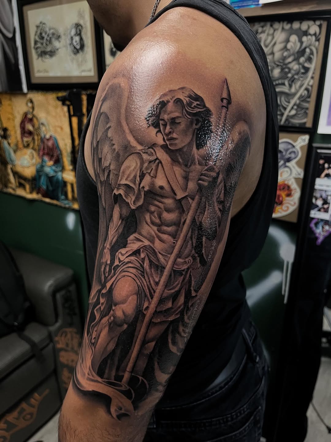 Angel with spear realism tattoo on the upper arm by Denver Tattoo Artist