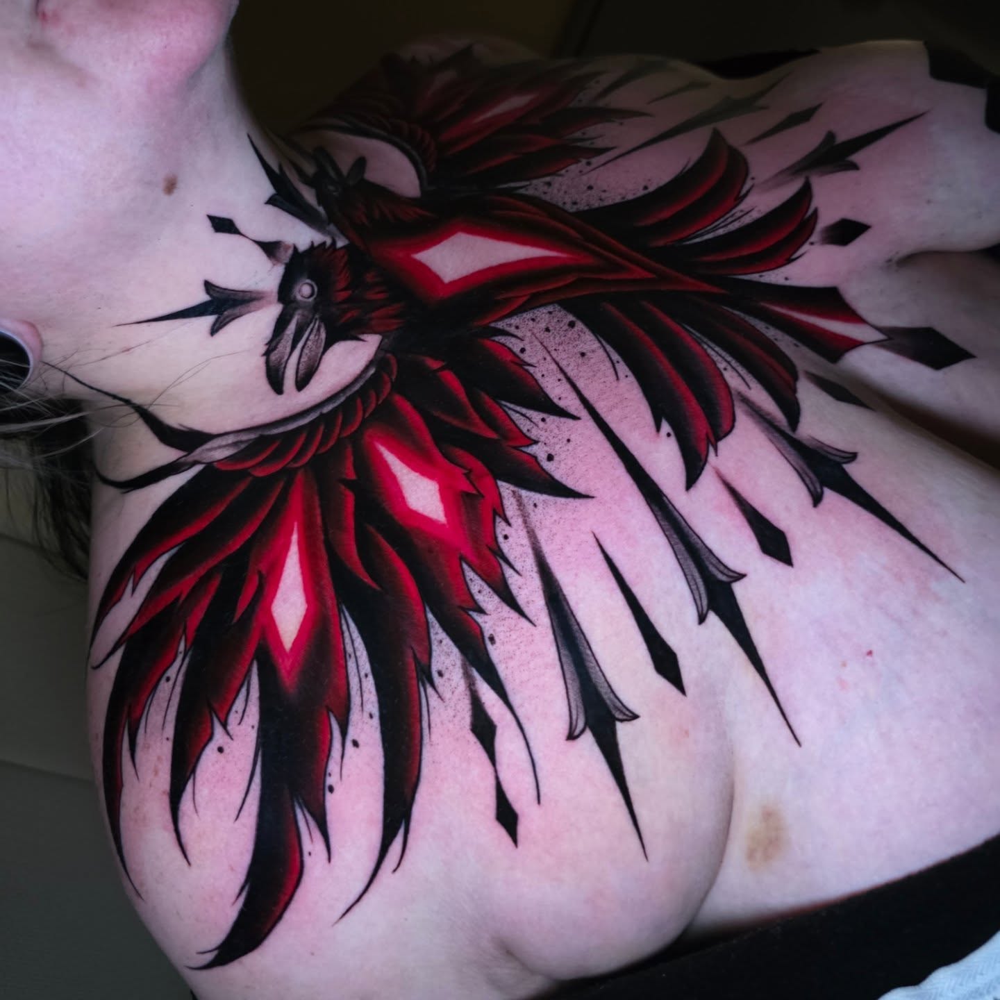 Red phoenix neo-traditional tattoo on the chest by Kelsey Lorrae, Ankeny, Iowa