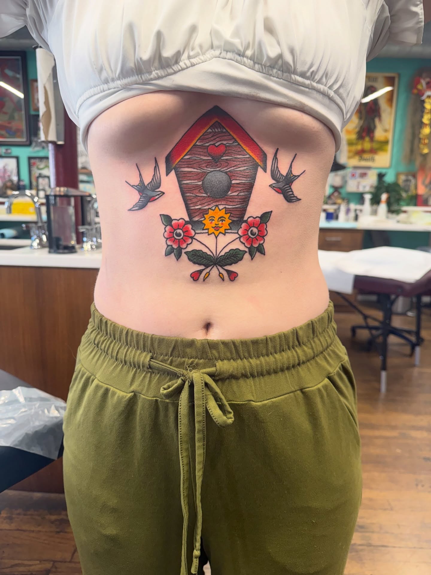 Birdhouse and swallow American traditional tattoo on the torso by Aaron ulfstam
