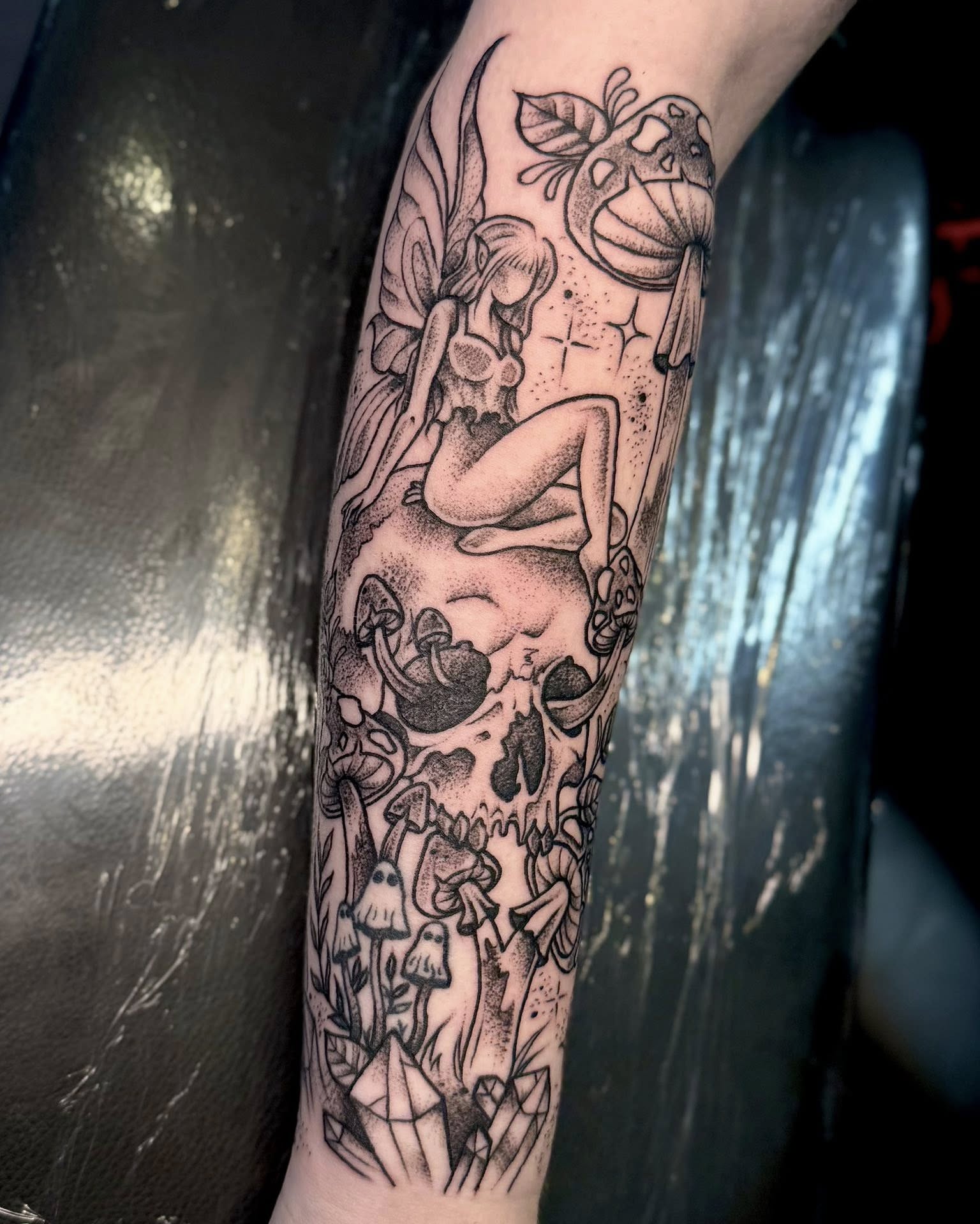 Fairy and skull dotwork tattoo on the forearm by Eden Rose, Kalama, Washington