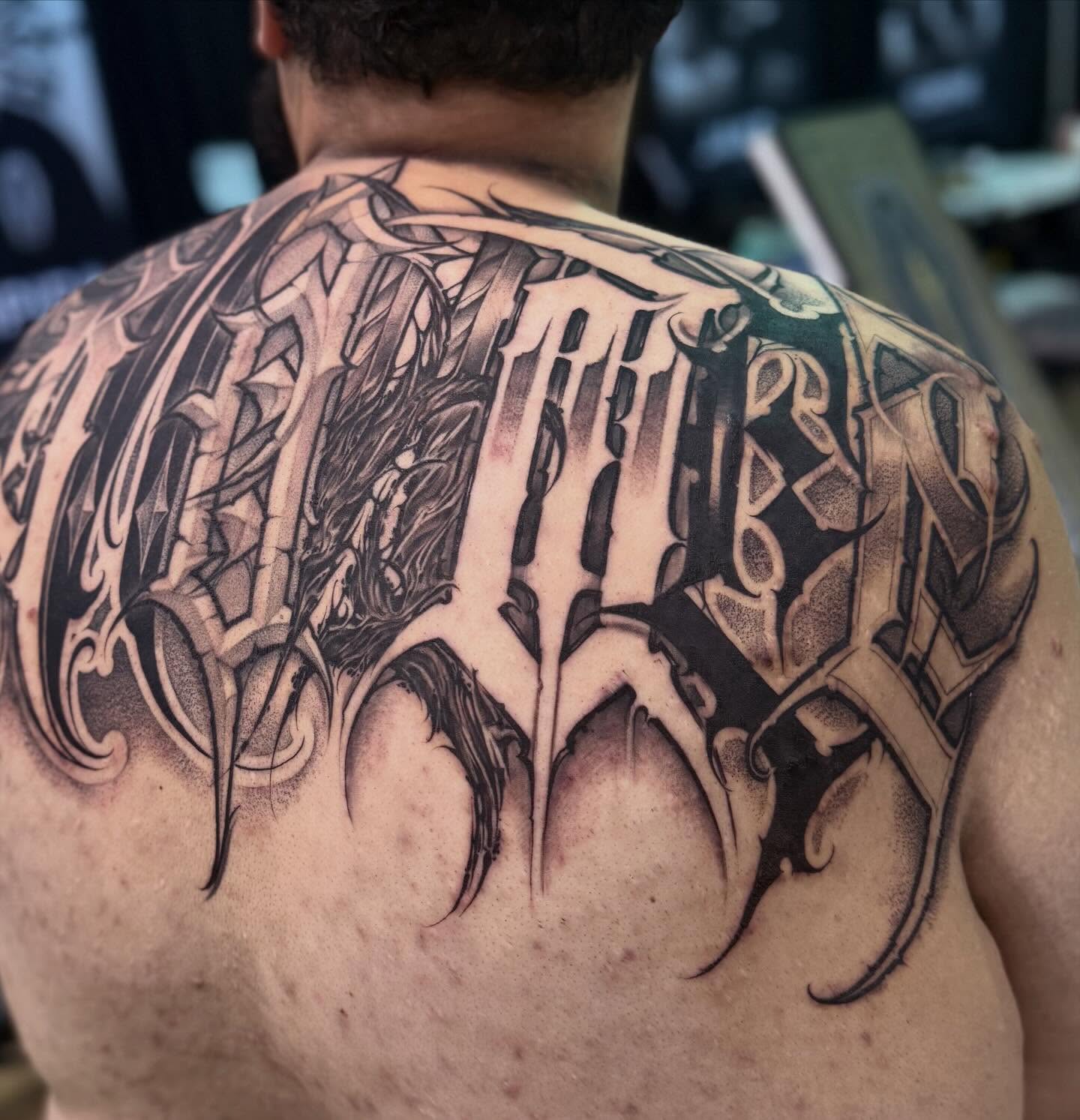 Gothic lettering lettering script tattoo on the back by Ashley brown, Las Vegas, Nevada