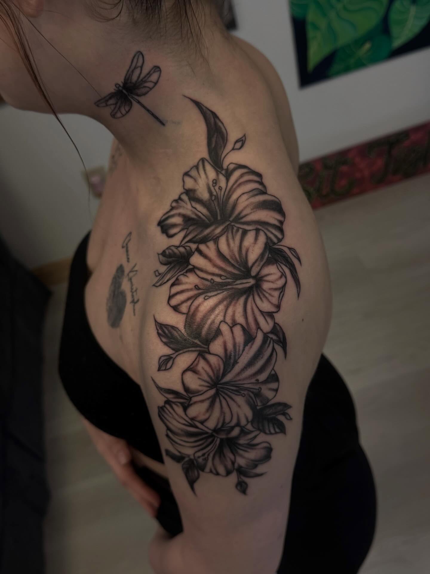 Lilies realism tattoo on the shoulder by Gigi