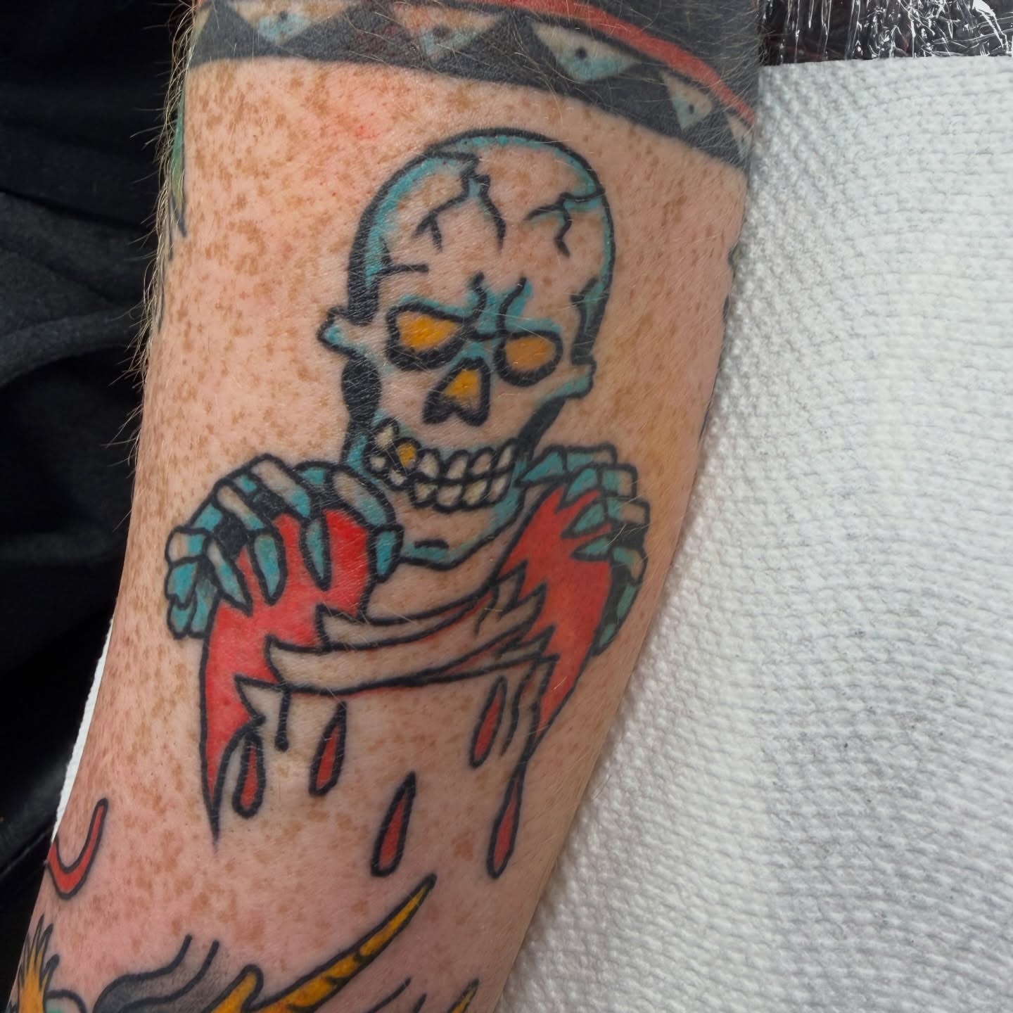 Skull holding heart American traditional tattoo on the forearm by c☮︎urt