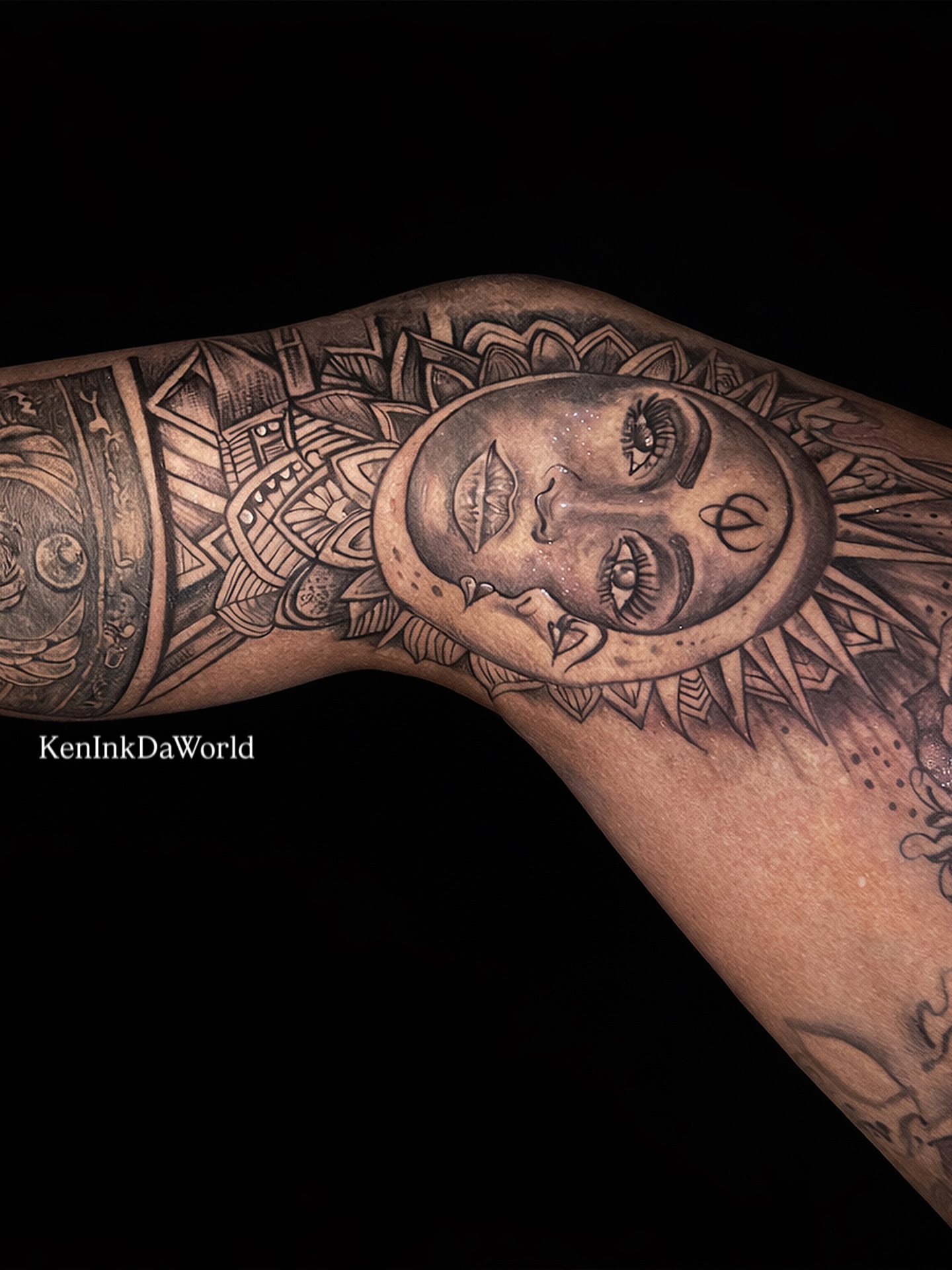 Face with geometric patterns tribal tattoo on the upper arm by Ken West