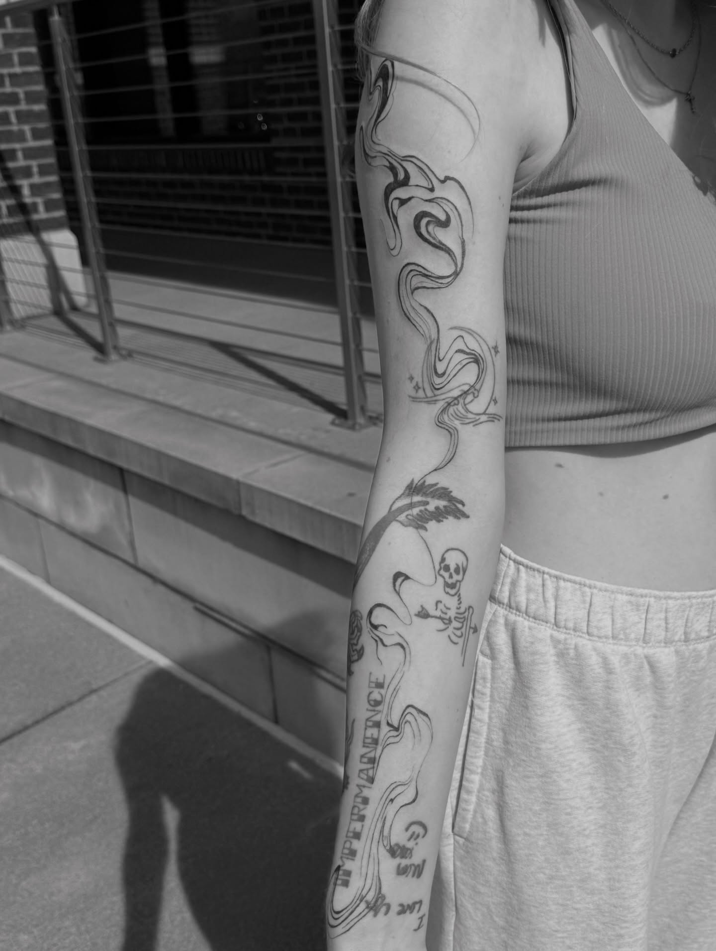 Smoke and skull black and grey tattoo on the forearm by Ryleigh Benjamin