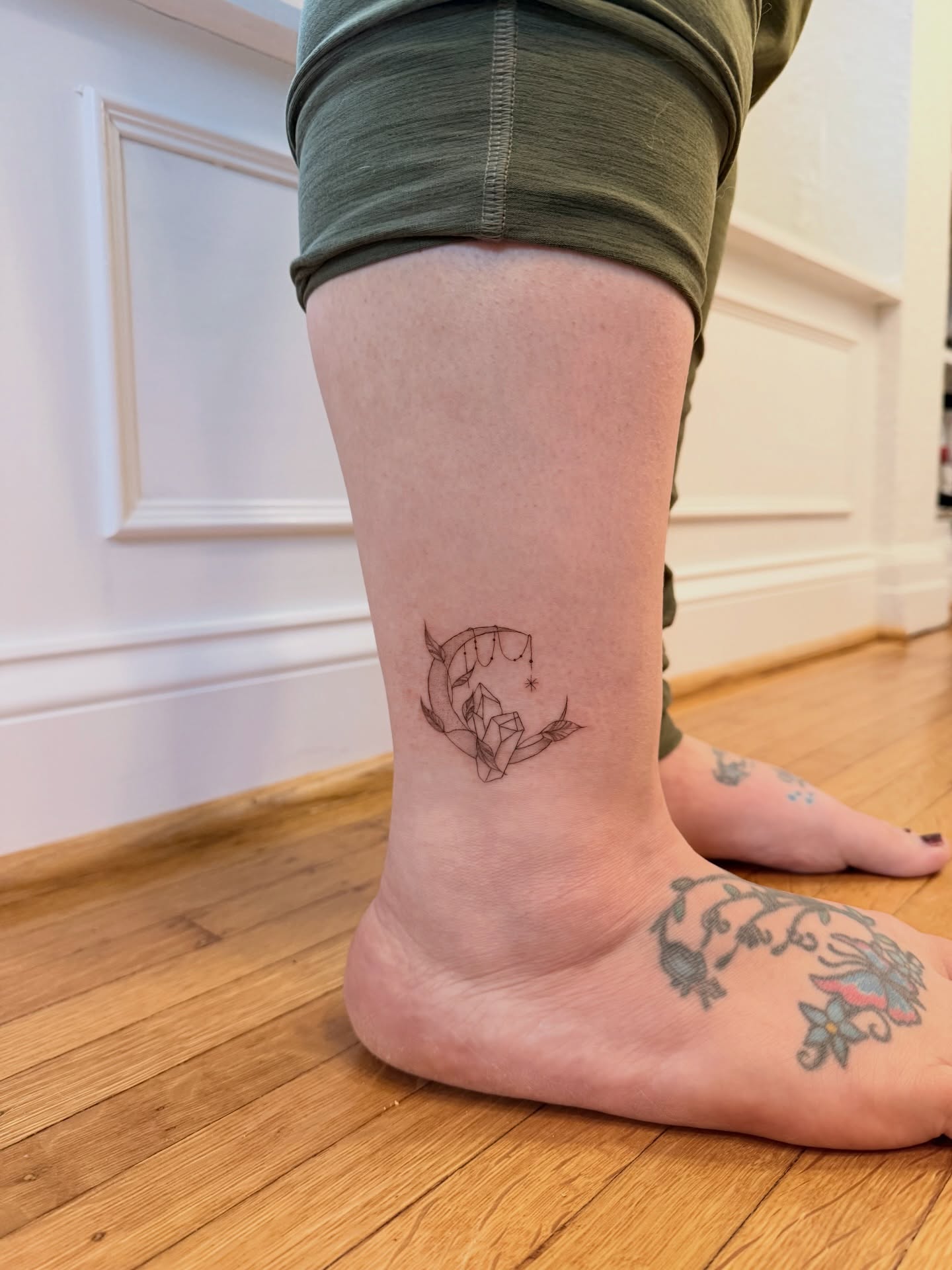 Moon and crystal geometric tattoo on the calf by Reverie Studio
