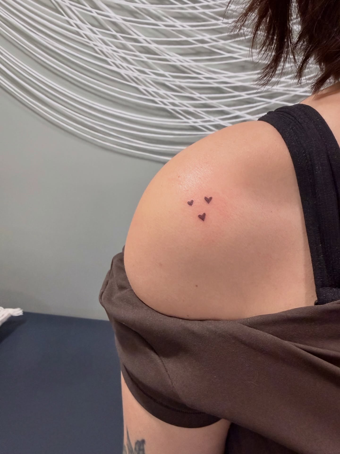 Three hearts minimalist tattoo on the shoulder by Reverie Studio