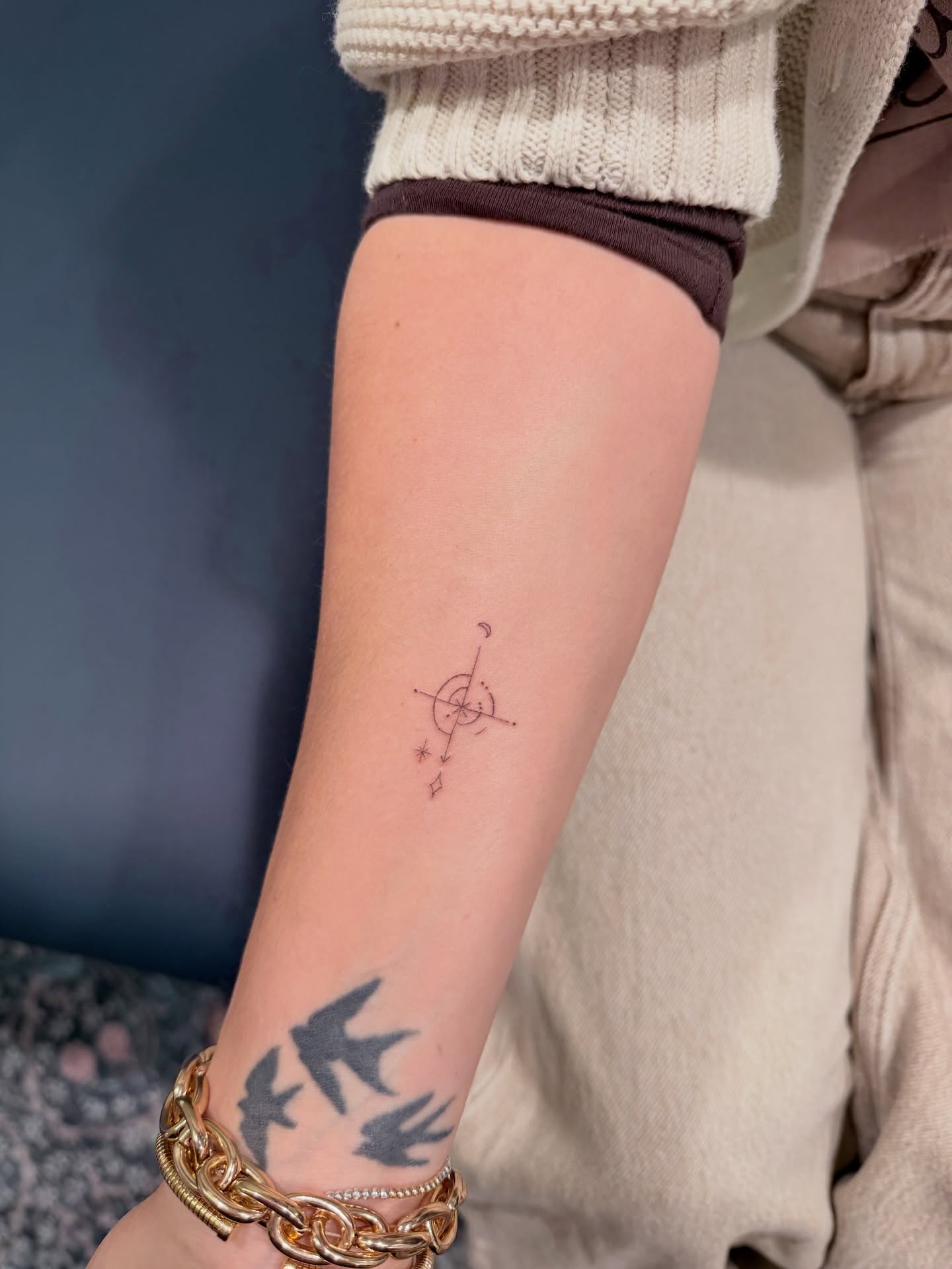 Compass and stars geometric tattoo on the forearm by Reverie Studio