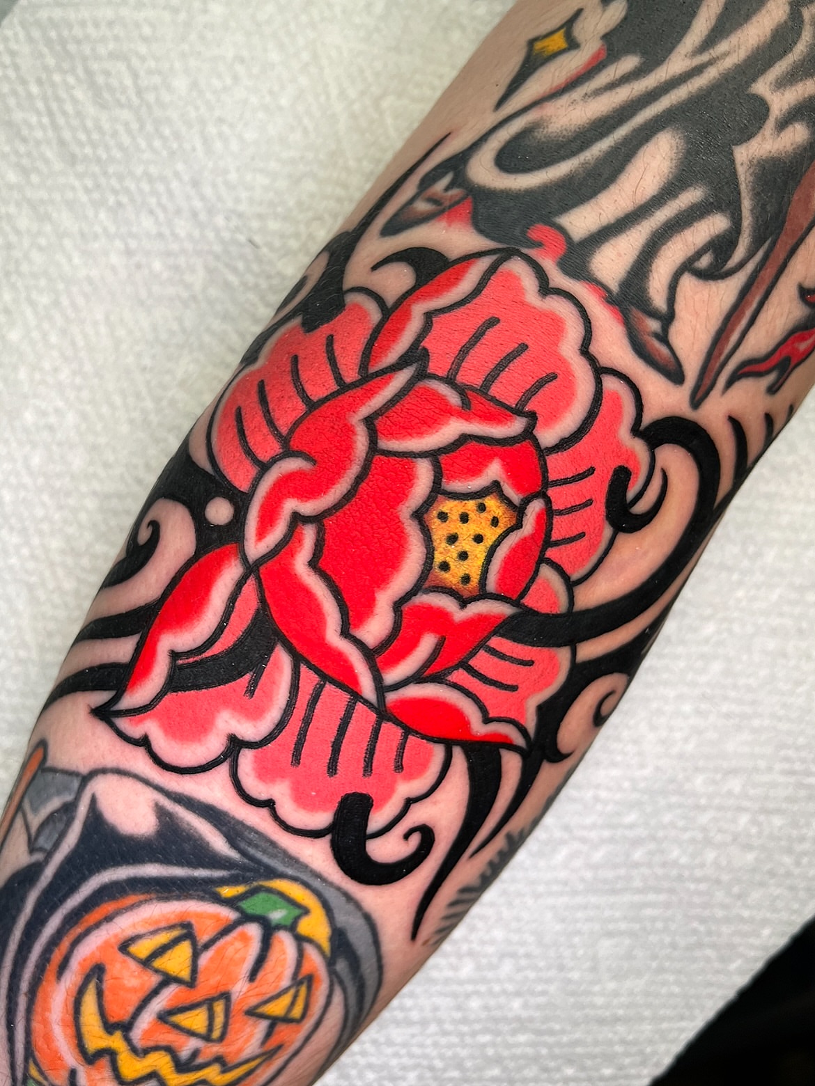 Red flower American traditional tattoo on the forearm by π΅ππππ π¬ππππ