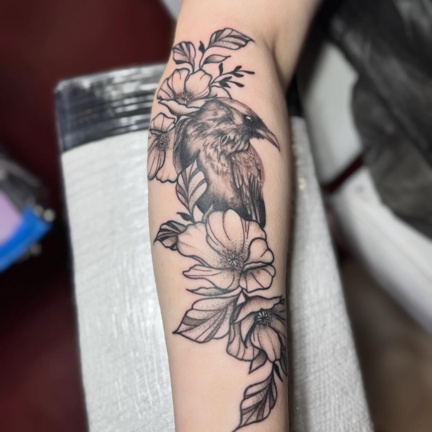 Bird and flowers black and grey tattoo on the forearm by 🪬🍄Larissa Potter🍄🪬
