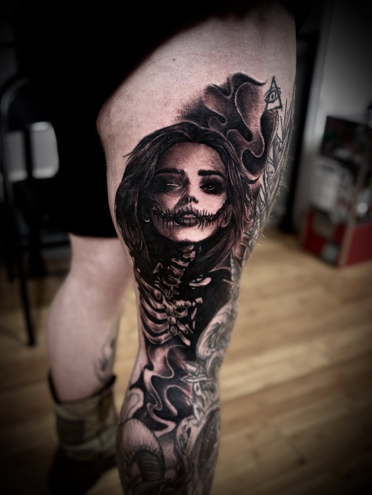 Woman with skeleton dark realism tattoo on the thigh by Ty East