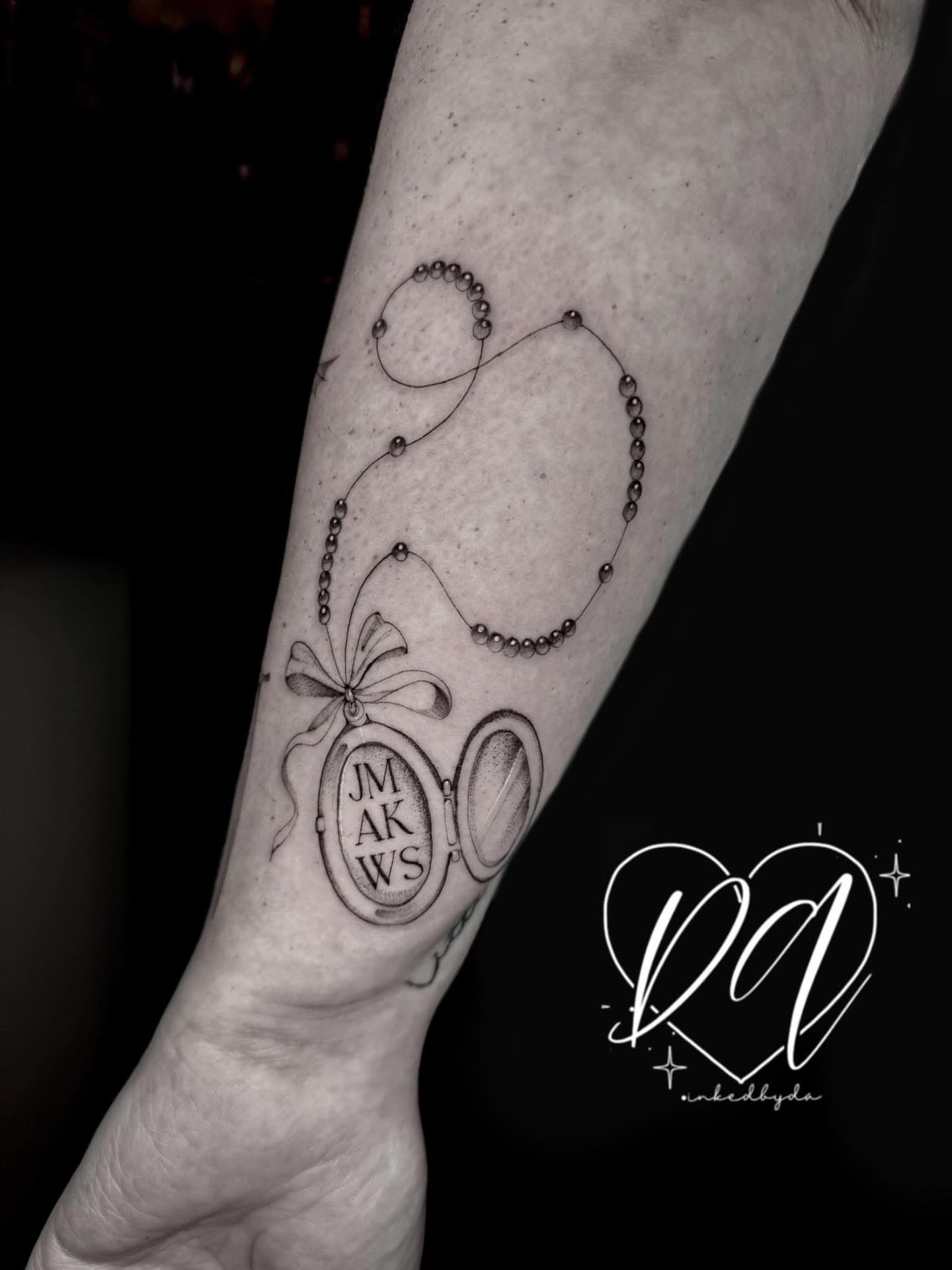Lock and key black and grey tattoo on the forearm by Dalton Alexandria