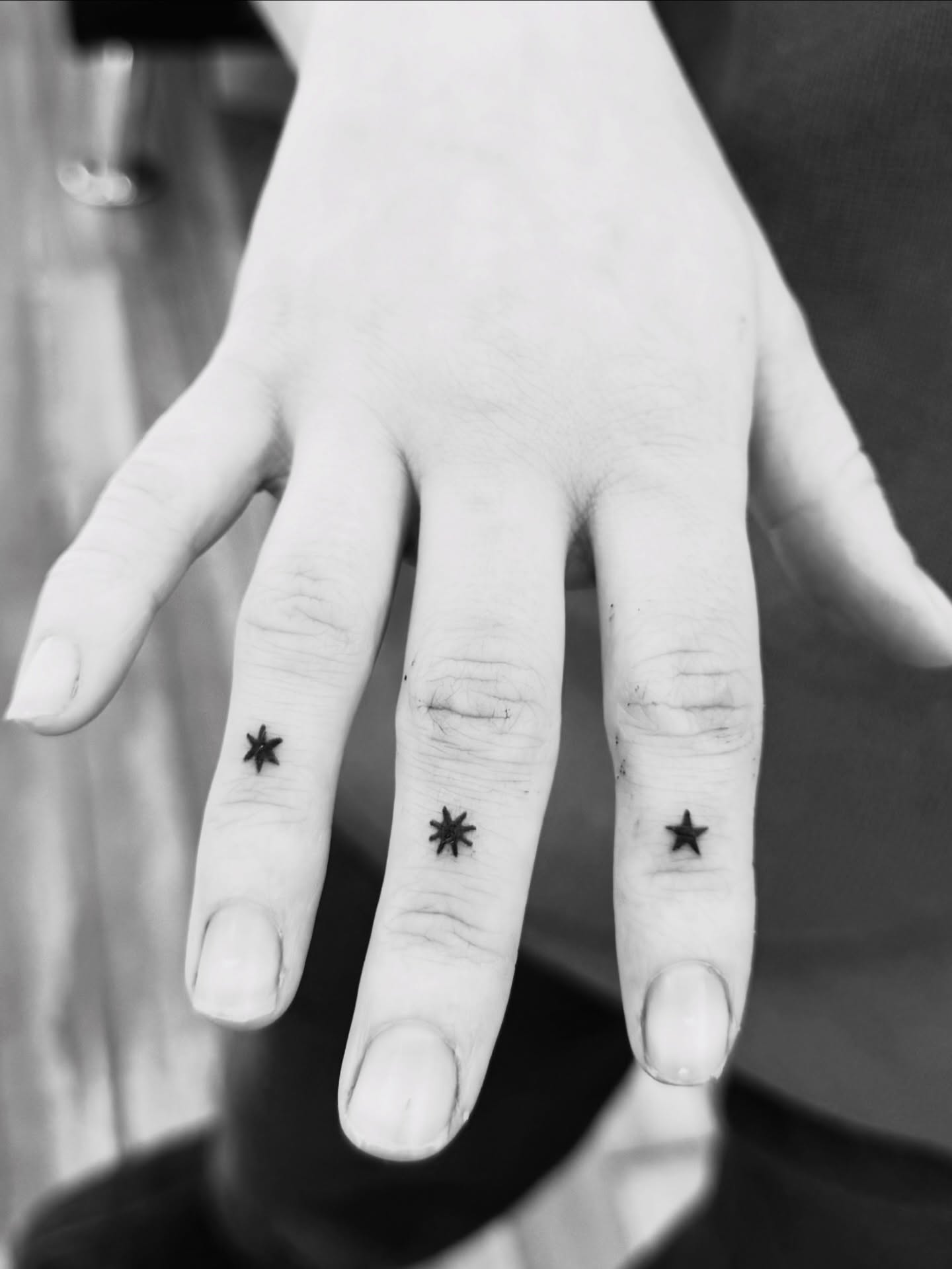 Stars black and grey tattoo on the hand by Lindsay Shriver