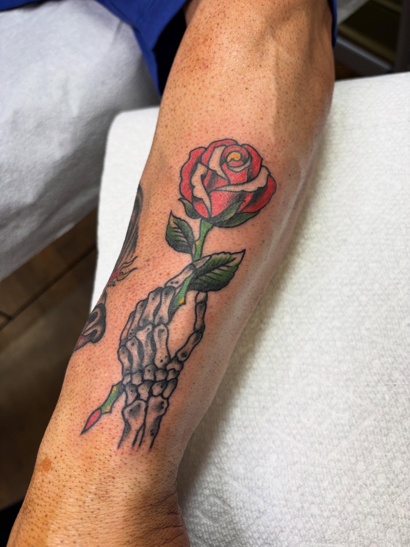 Rose American traditional tattoo on the forearm by Mike DiCicco