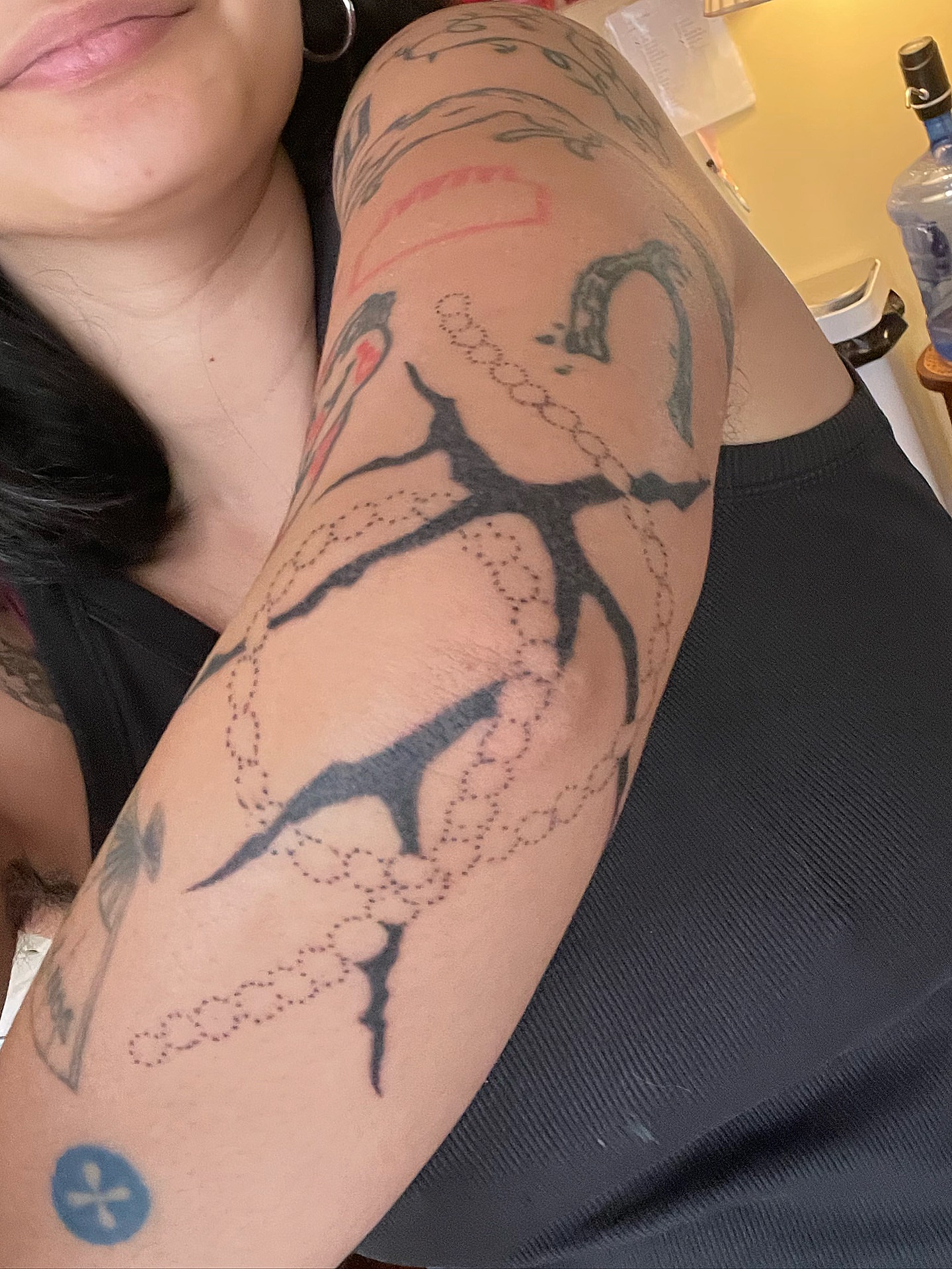 Snake and chain dotwork tattoo on the upper arm by cait