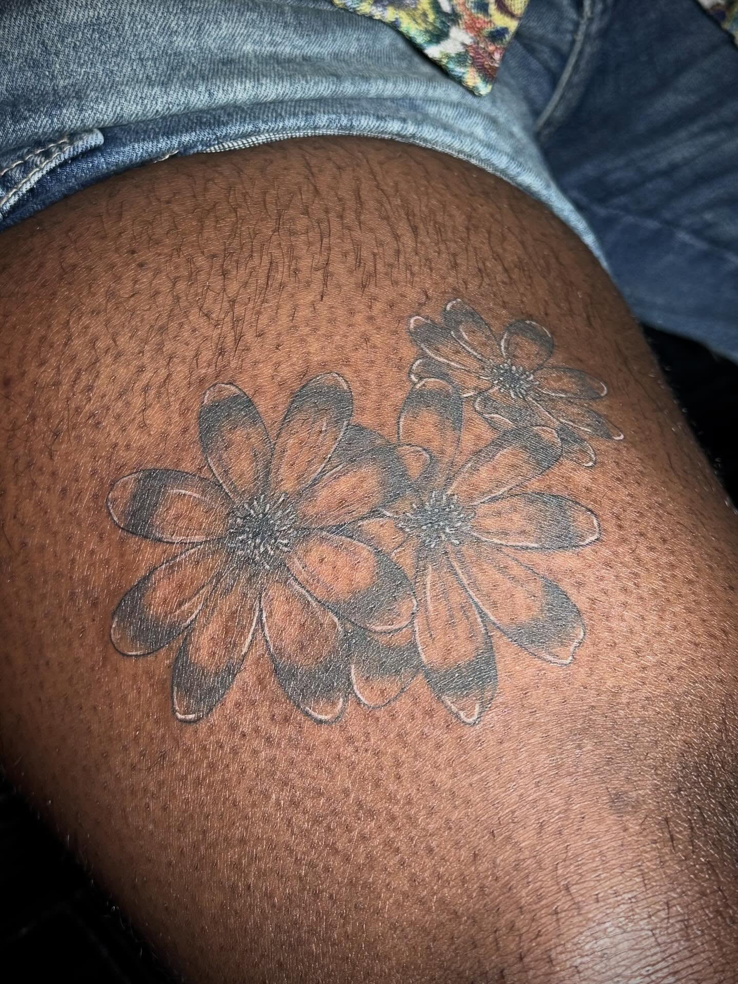 Flowers black and grey tattoo on the thigh by abbie michelle