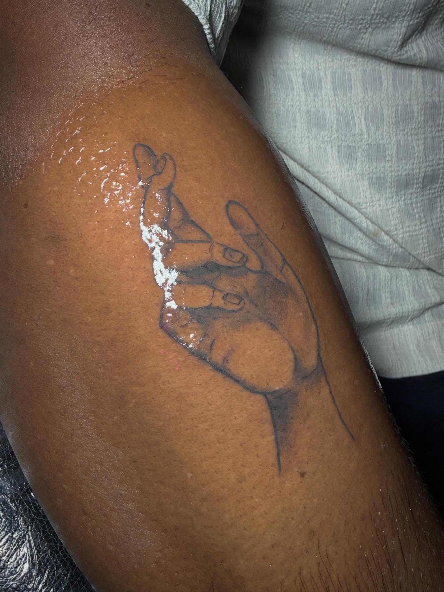 Hands black and grey tattoo on the upper arm by abbie michelle