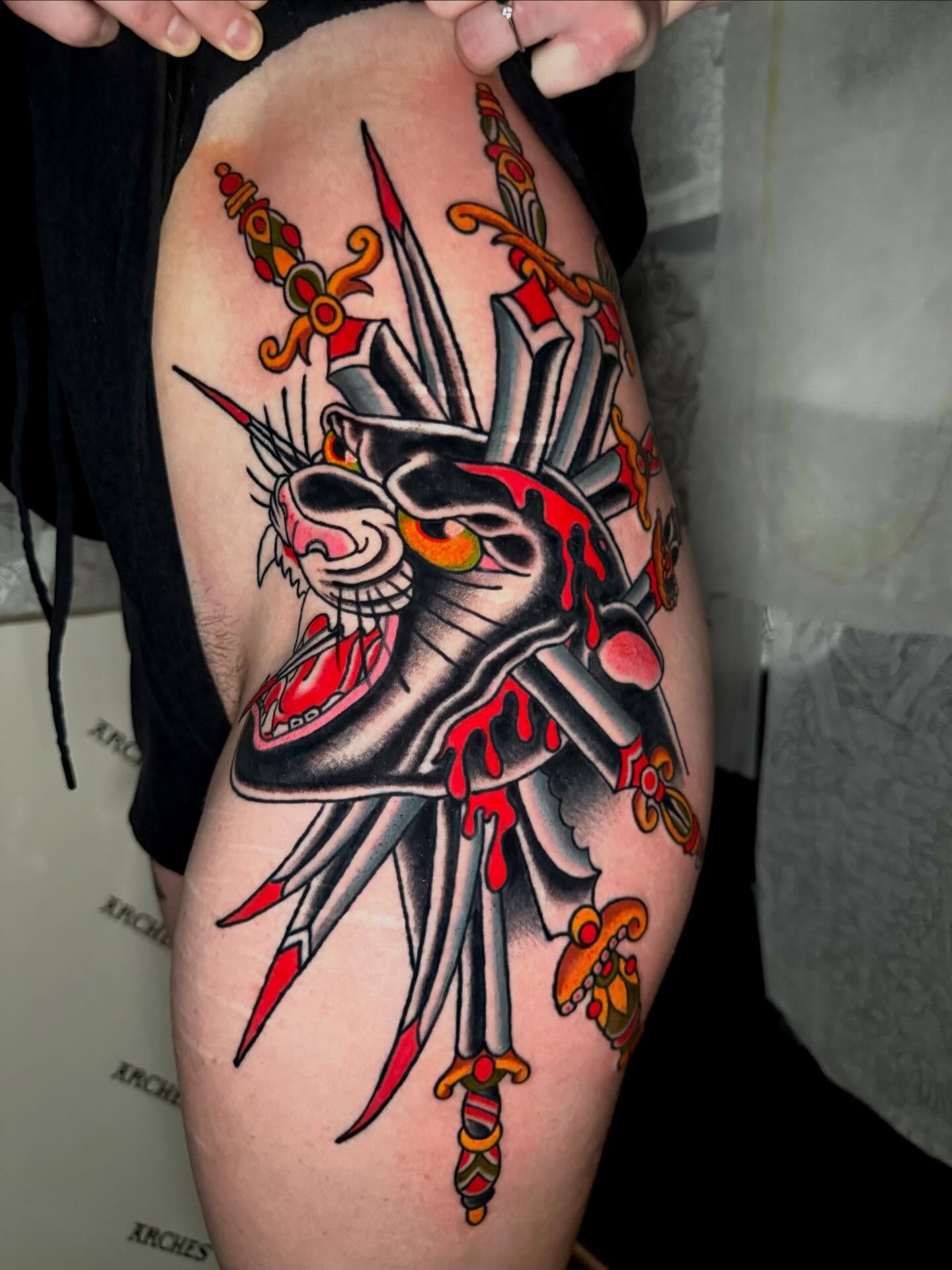 Cat with swords American traditional tattoo on the thigh by Seth Walker