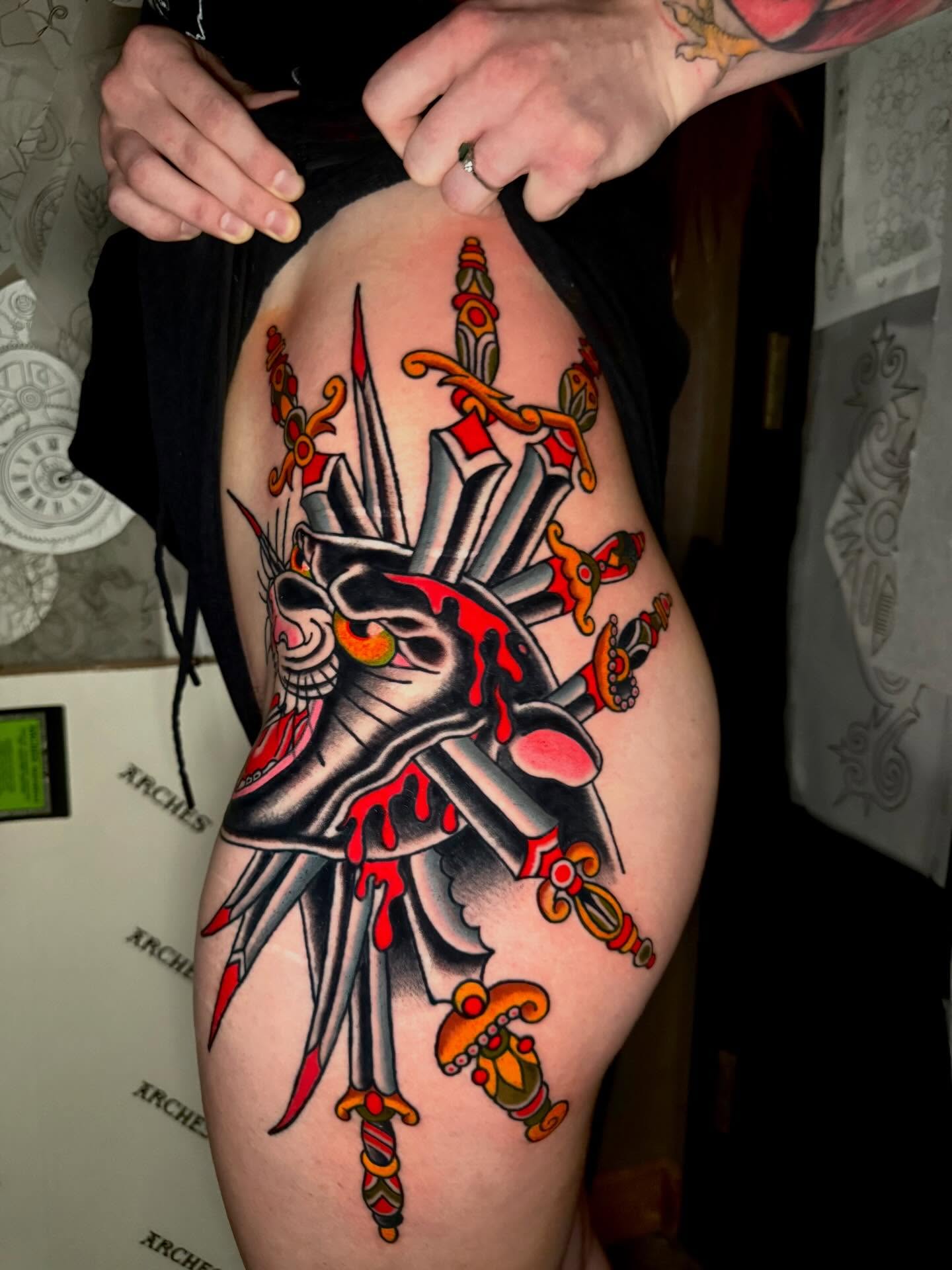 Skull with swords American traditional tattoo on the thigh by Seth Walker