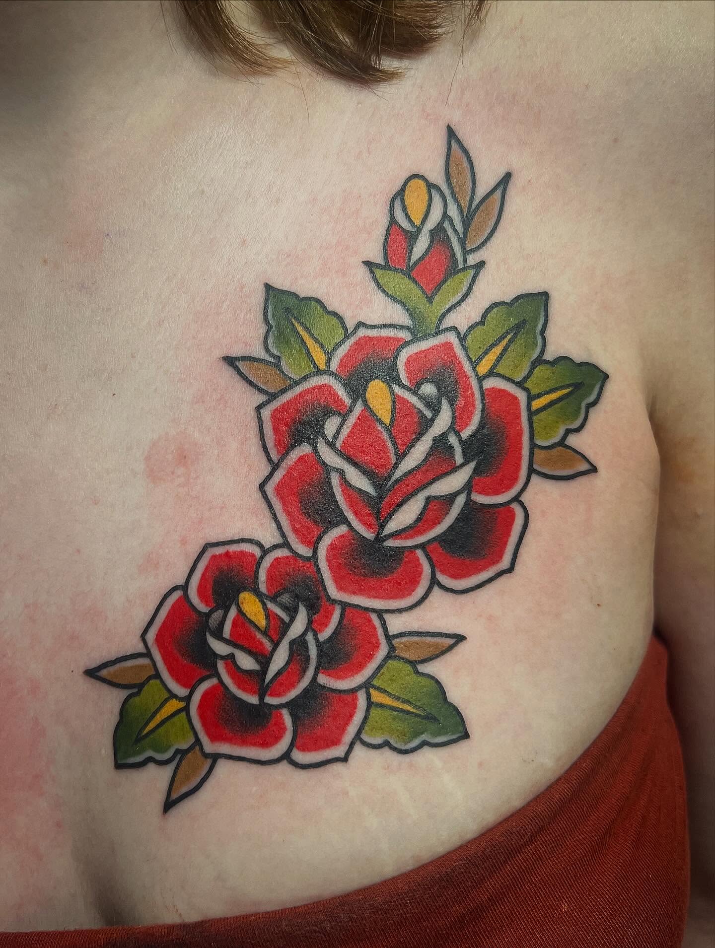 Roses American traditional tattoo on the chest by Taylor Estrella