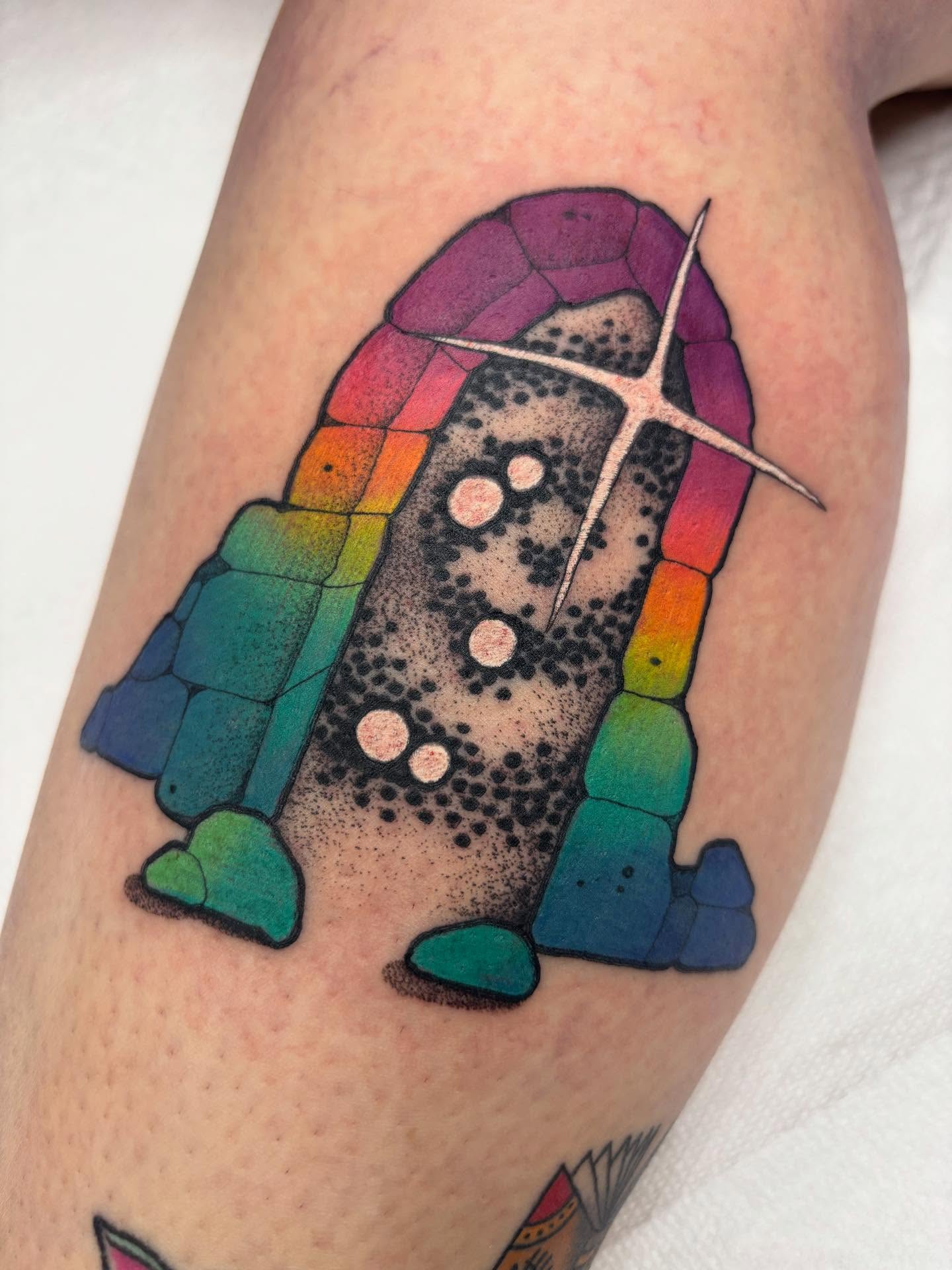 Rainbow rocket dotwork tattoo on the thigh by Carly Zehring