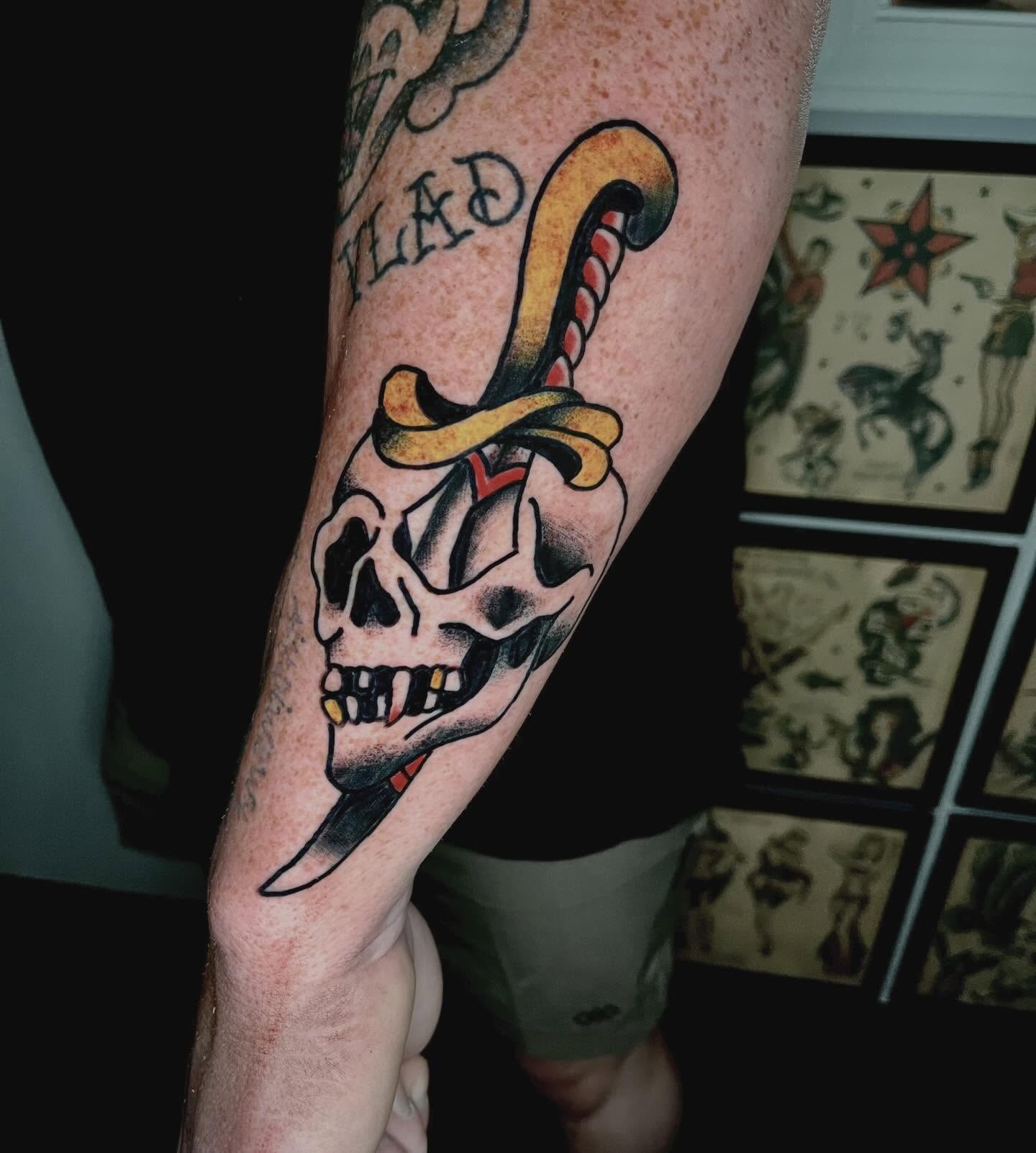 Skull and dagger American traditional tattoo on the forearm by Mason McCubbin