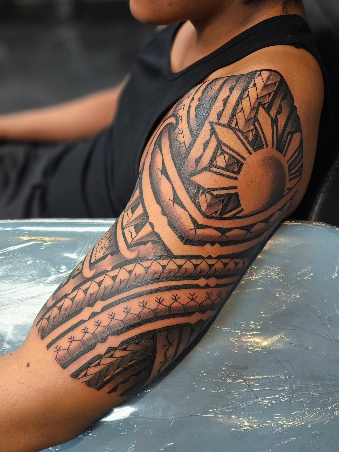 Tribal sun tribal tattoo on the forearm by Jo'el Acoba