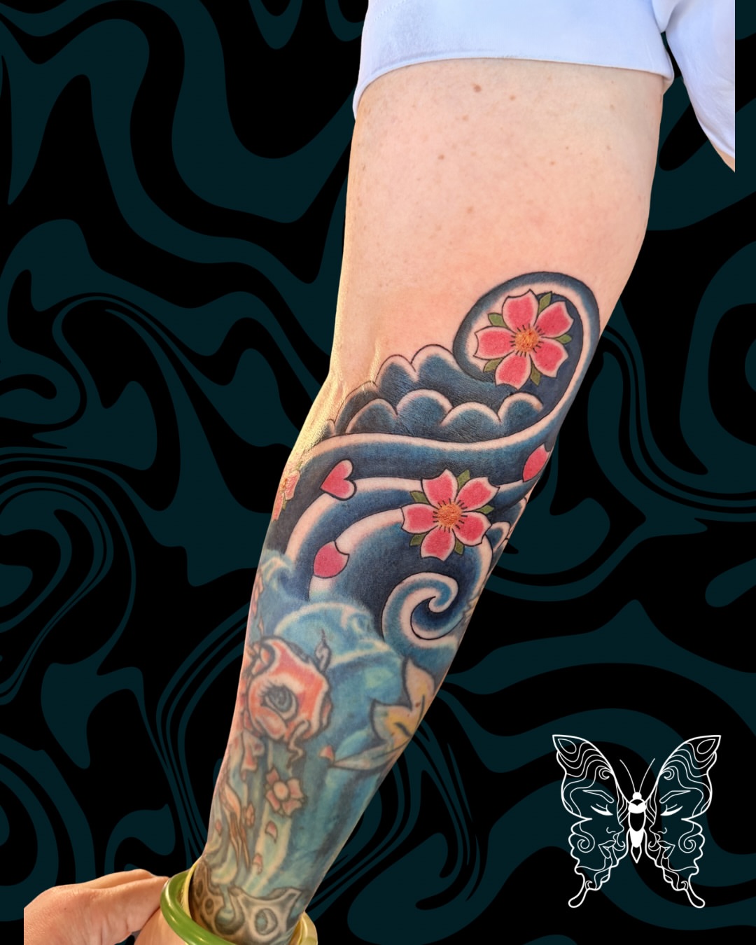 Cherry blossoms and koi fish japanese irezumi tattoo on the forearm by Nicci
