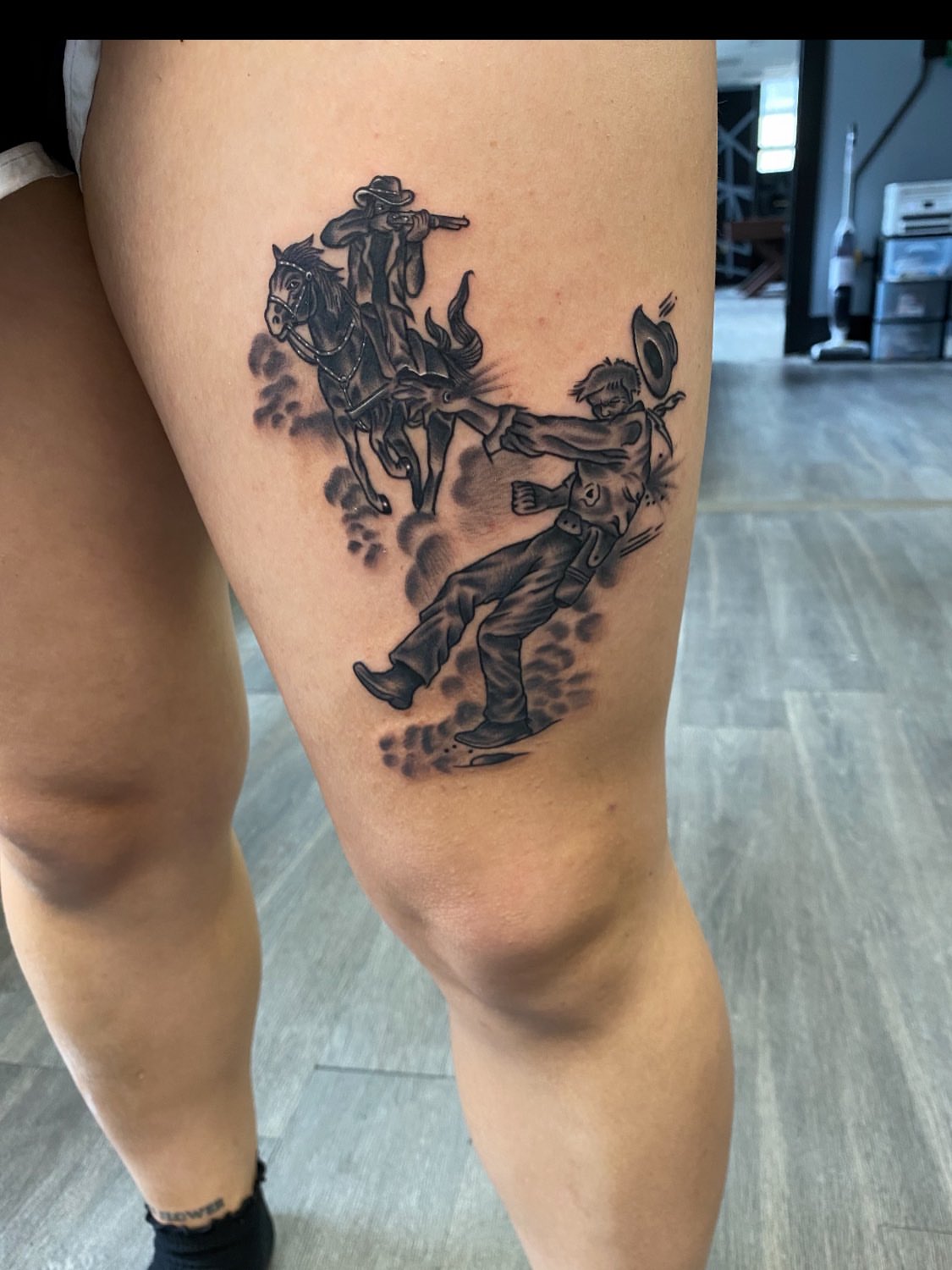 Cowboy and horse black and grey tattoo on the thigh by Kelan Mckenna