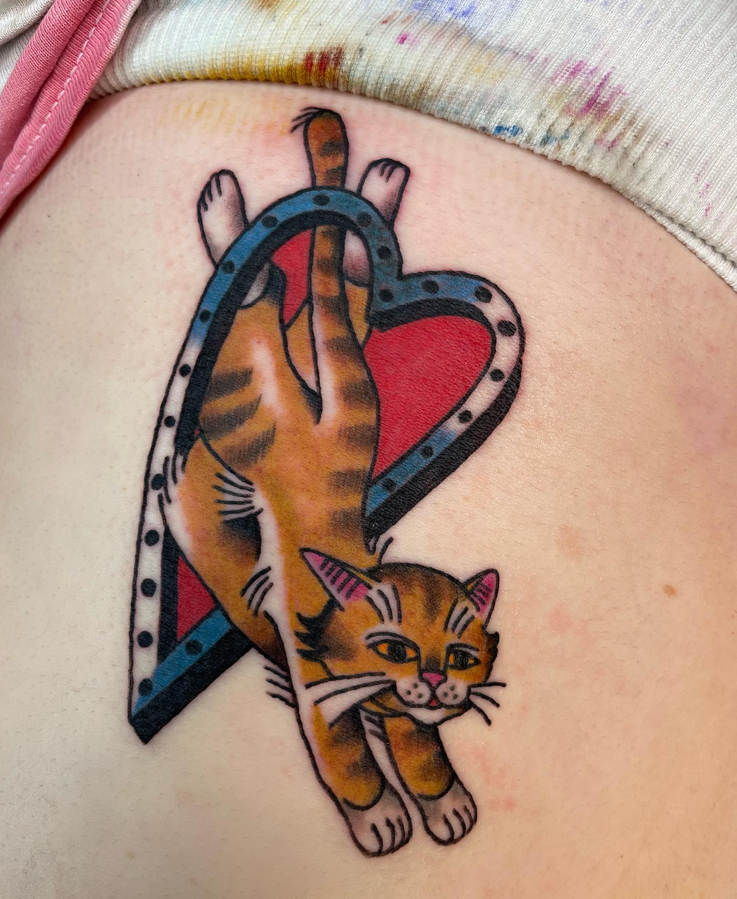 Cat and heart American traditional tattoo on the torso by Gerald Bellmore