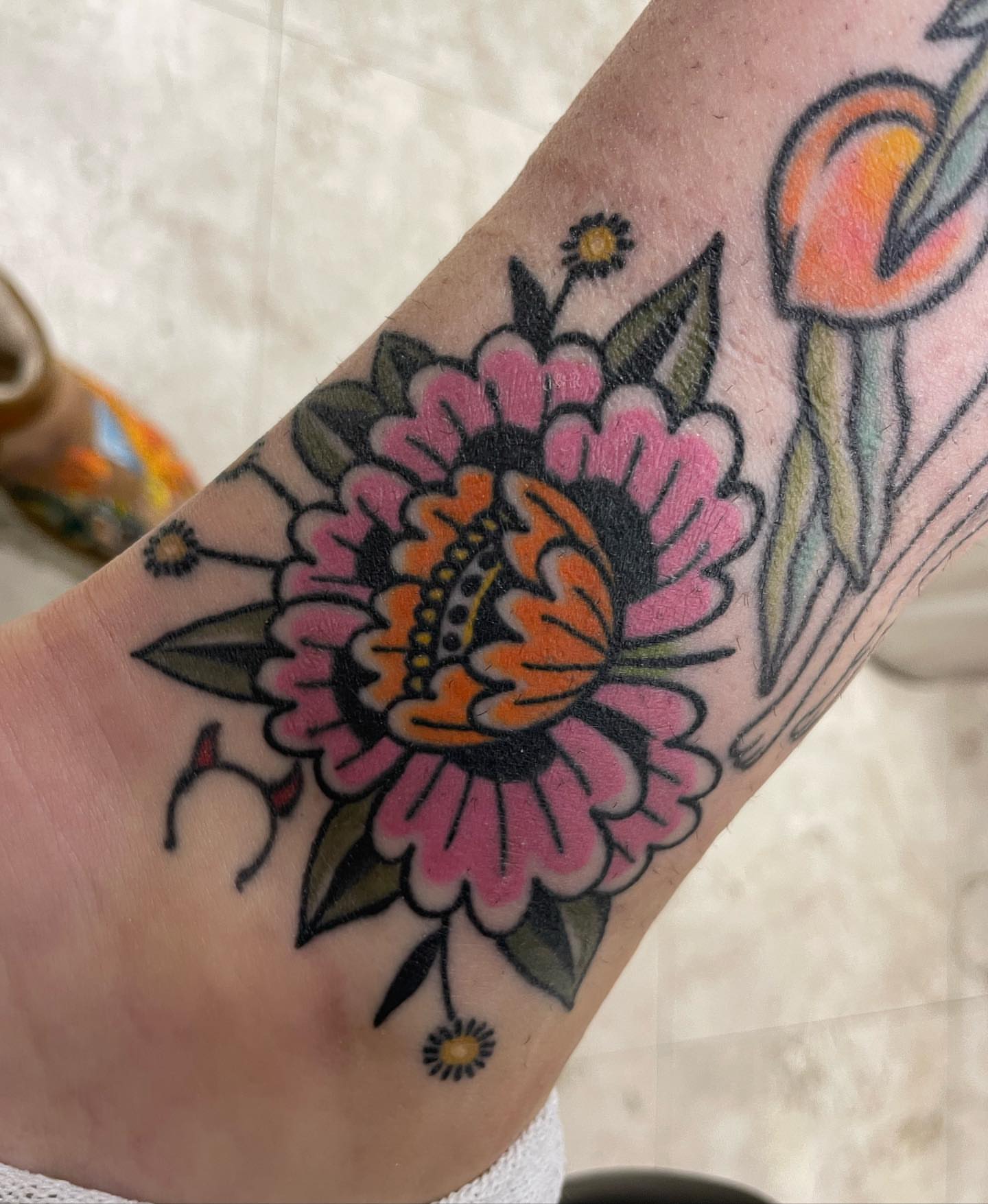 Floral arrangement American traditional tattoo on the forearm by Gerald Bellmore