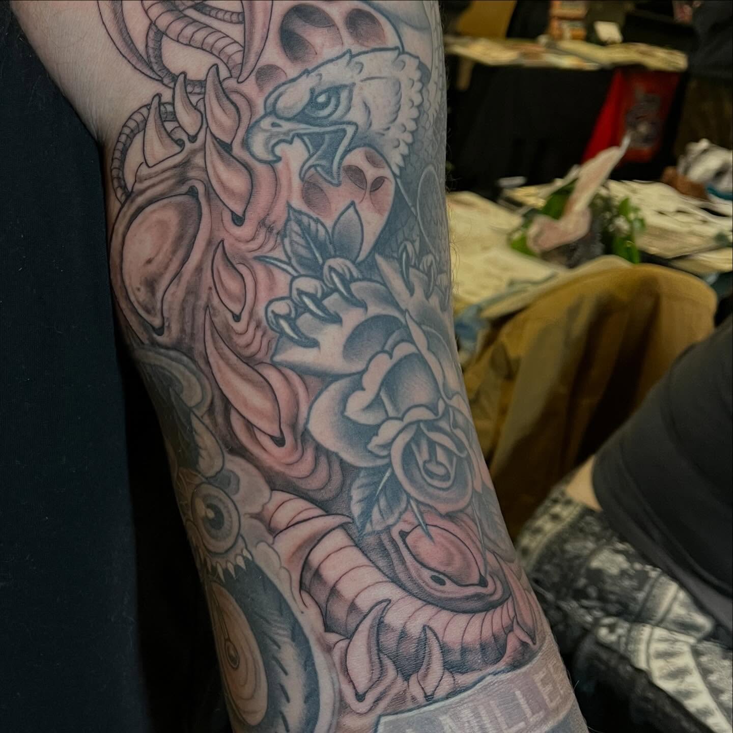 Eagle and roses American traditional tattoo on the forearm by Adam Habecker