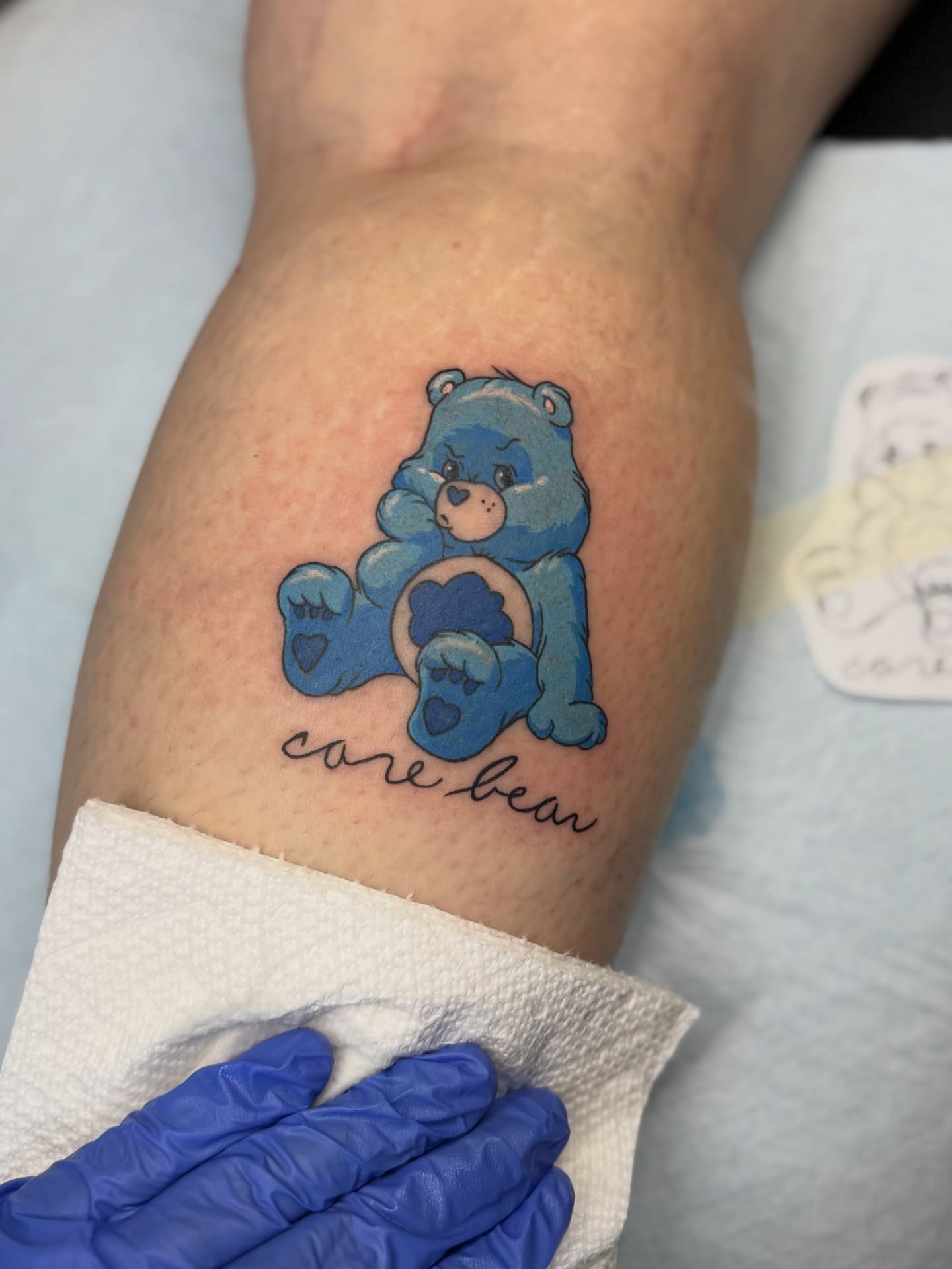 Care bear dotwork tattoo on the forearm by Minxxy Tattoos