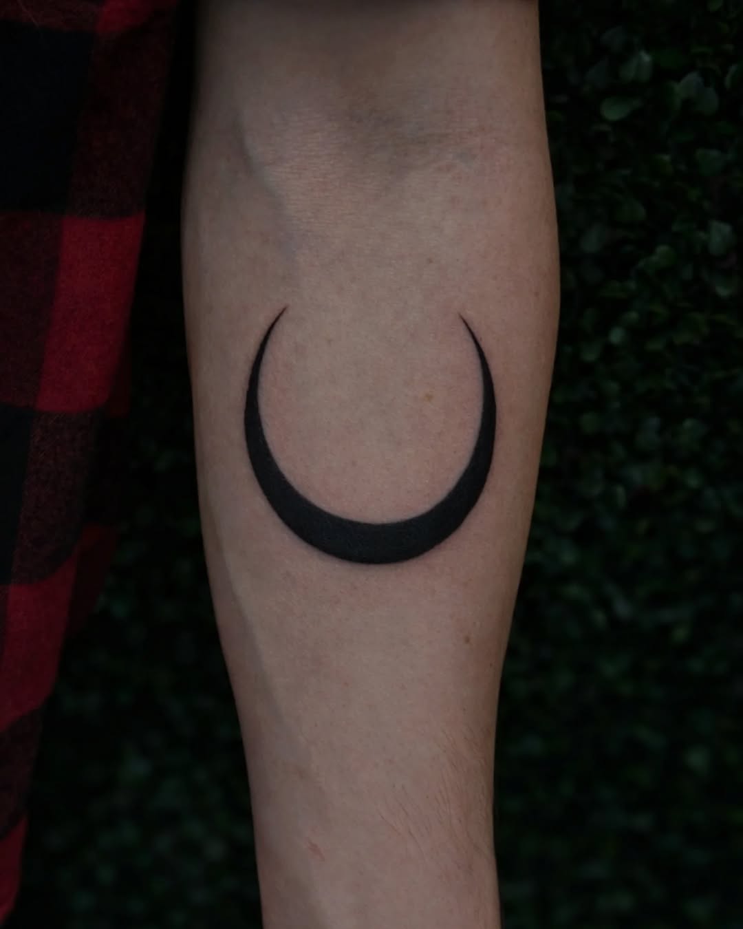 Crescent moon dotwork tattoo on the forearm by Marlayna Connelly