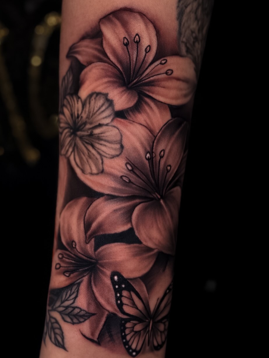 Flowers and butterfly realism tattoo on the forearm by Shane Boss, Toronto, Ontario