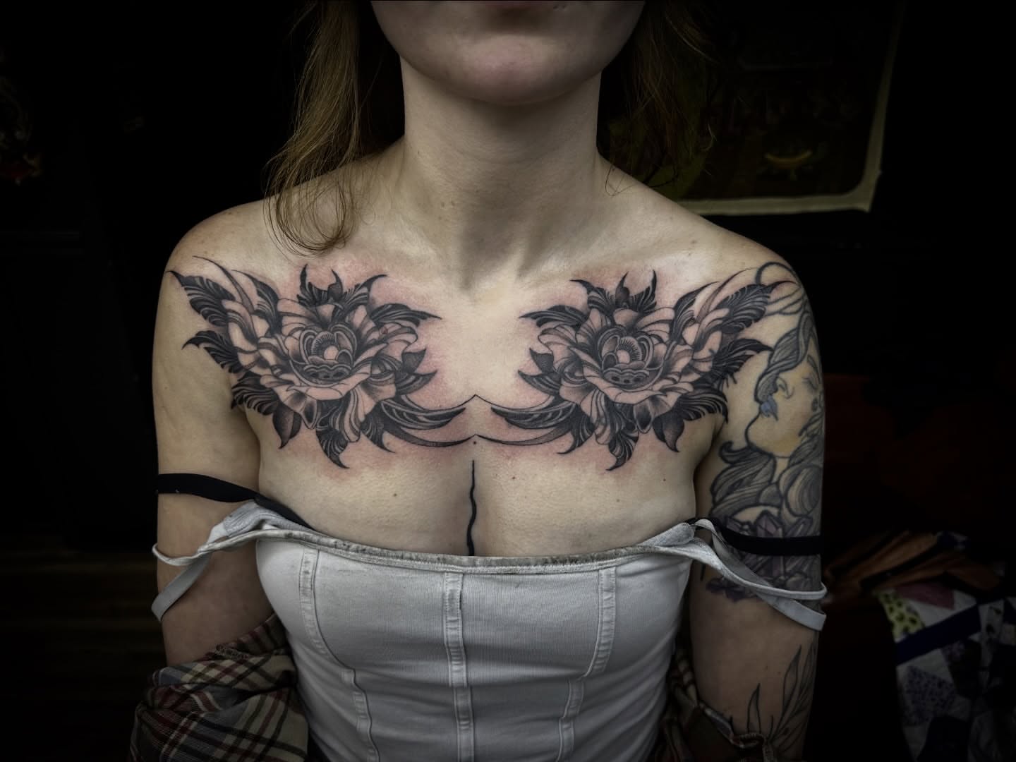 Floral black and grey tattoo on the chest by Kassie Perian