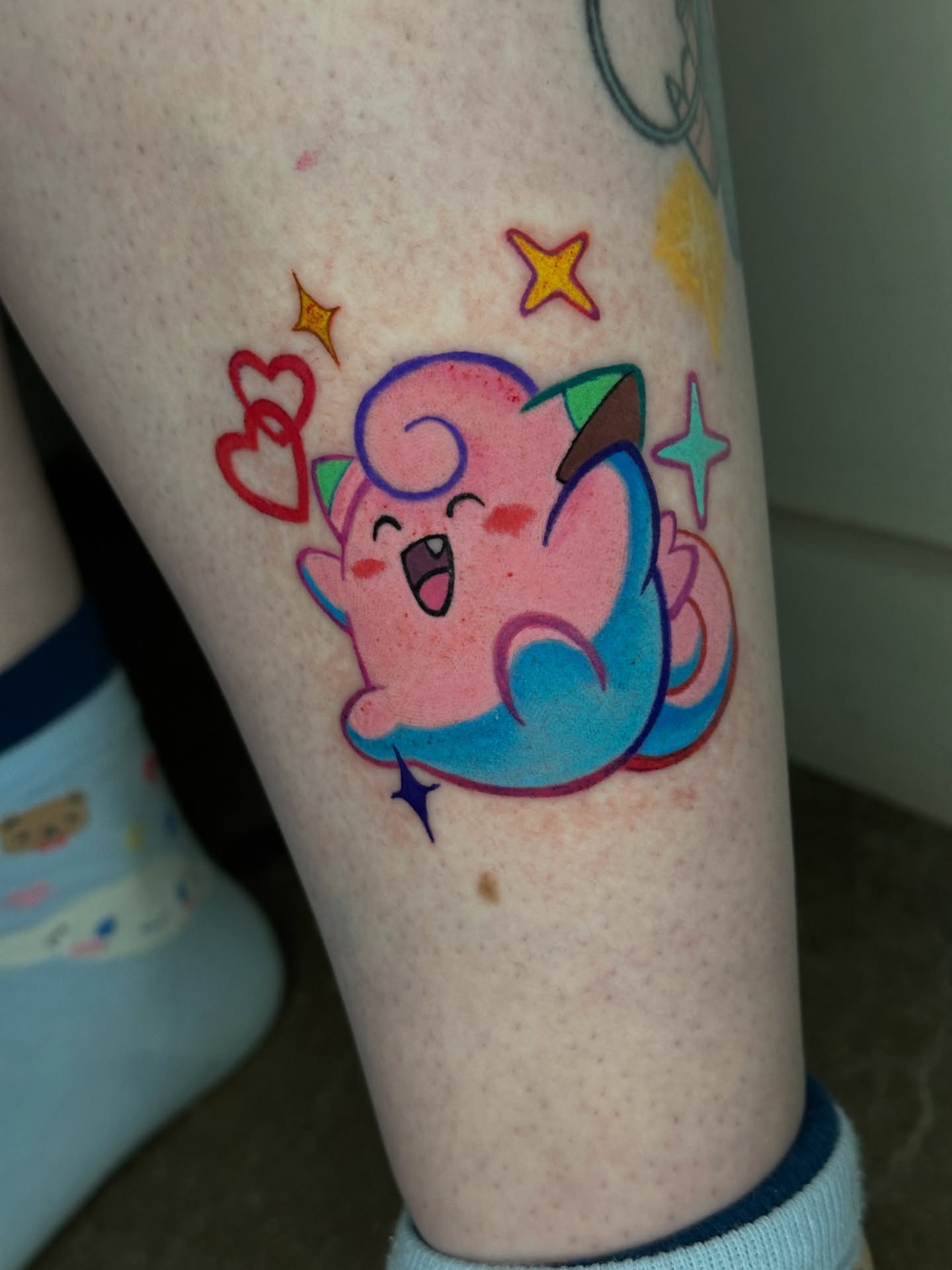 Kawaii character illustrative tattoo on the forearm by Dustin Hughes