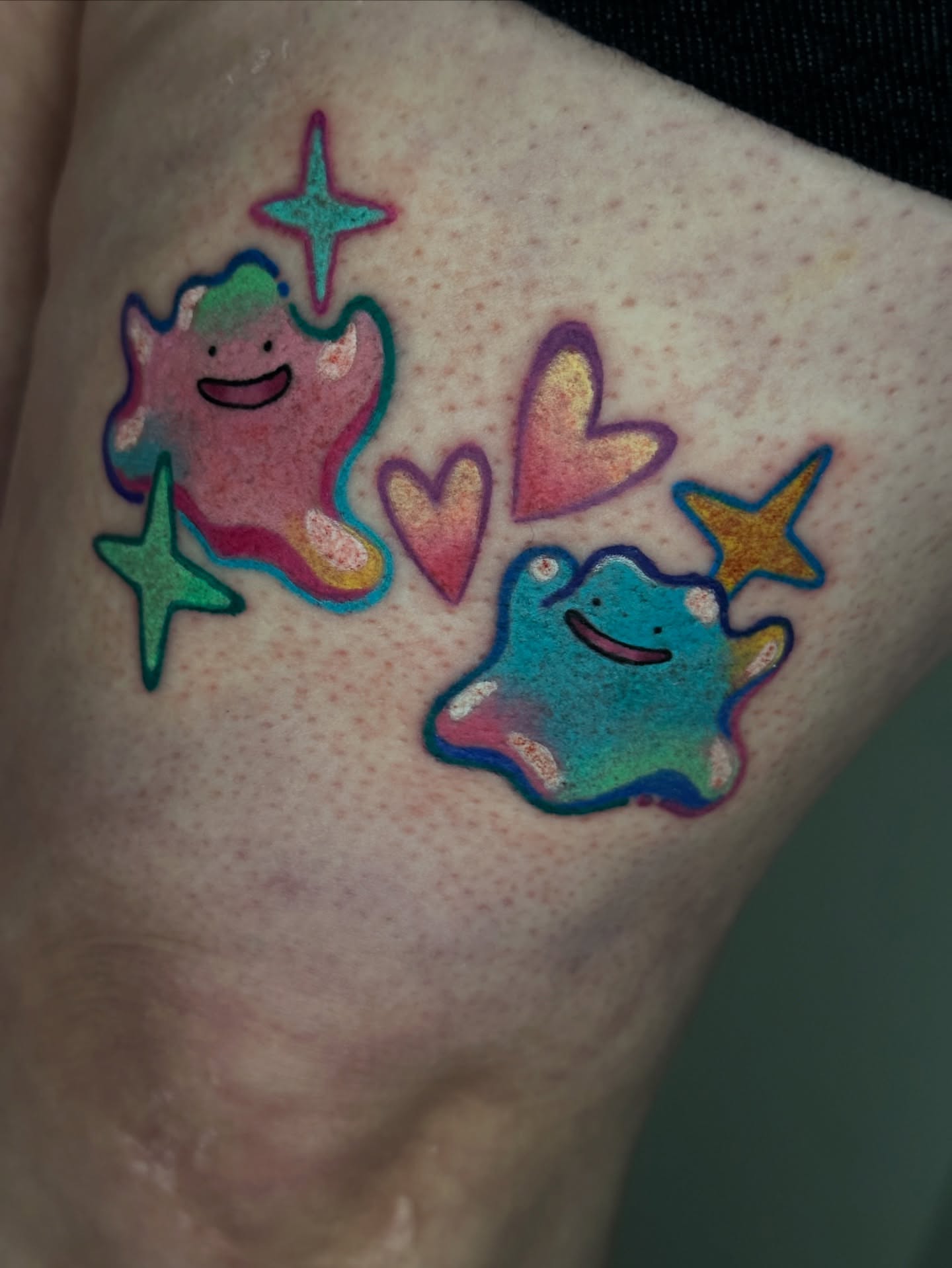 Two ghost-like creatures new school tattoo on the forearm by Dustin Hughes