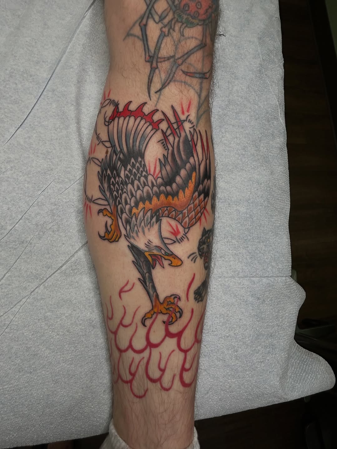 Eagle with flames American traditional tattoo on the forearm by Dane Mitchell