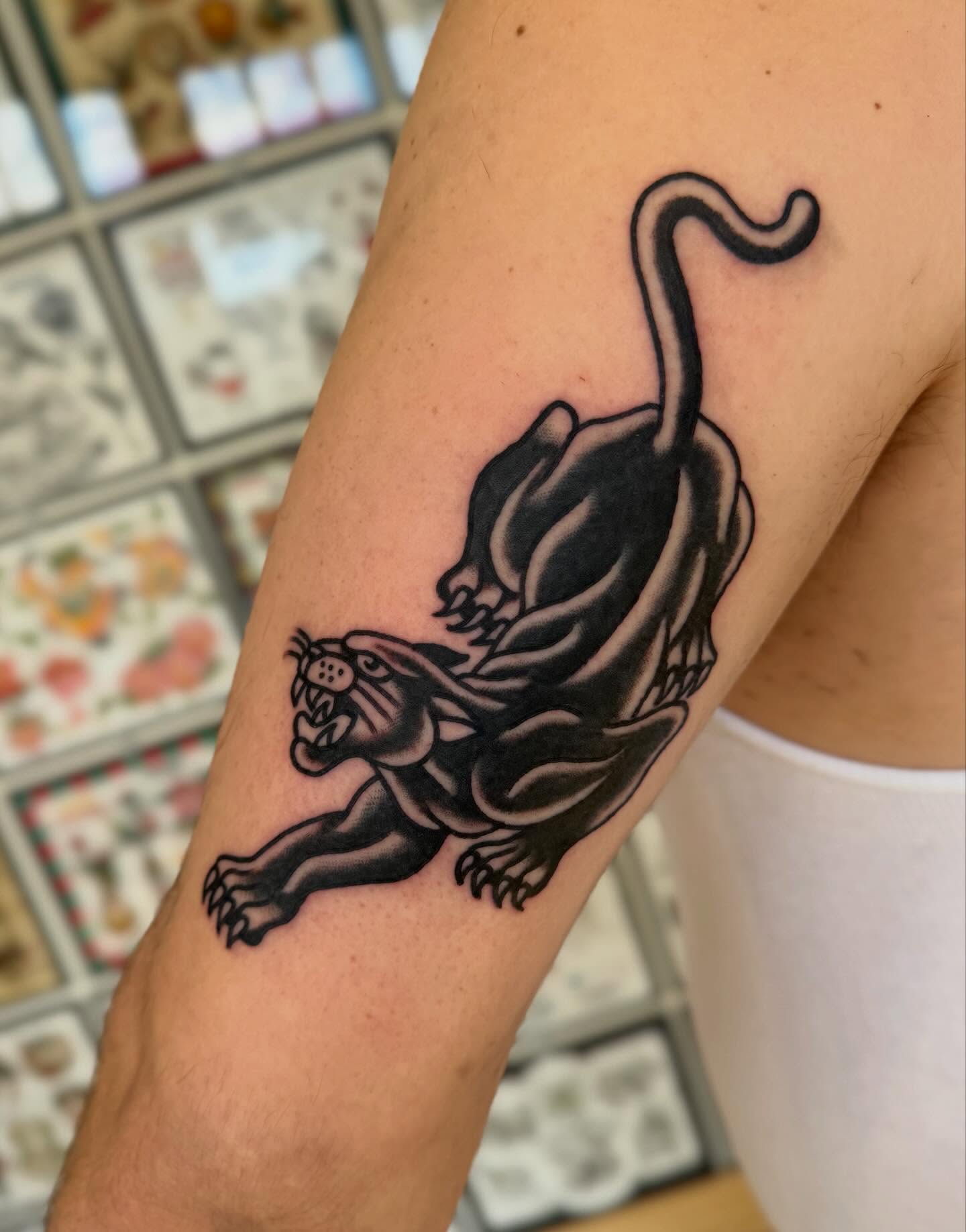 Panther black and grey tattoo on the forearm by Elle Yax