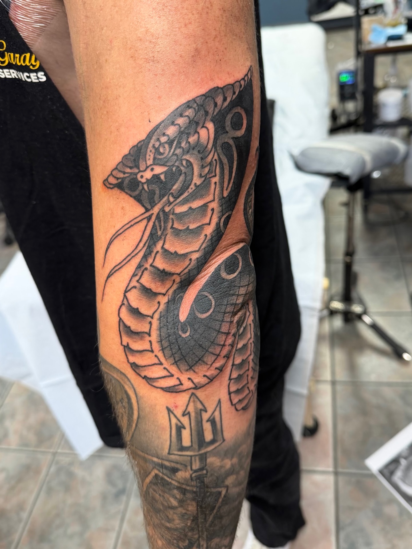 Snake and trident geometric tattoo on the forearm by Corey Thompson, Butler, Pennsylvania