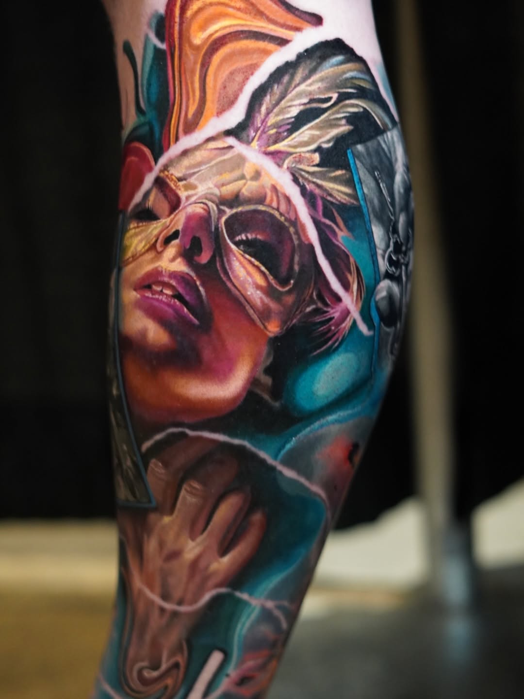 Woman with mask and hand surrealism tattoo on the forearm by Justin Shelpman