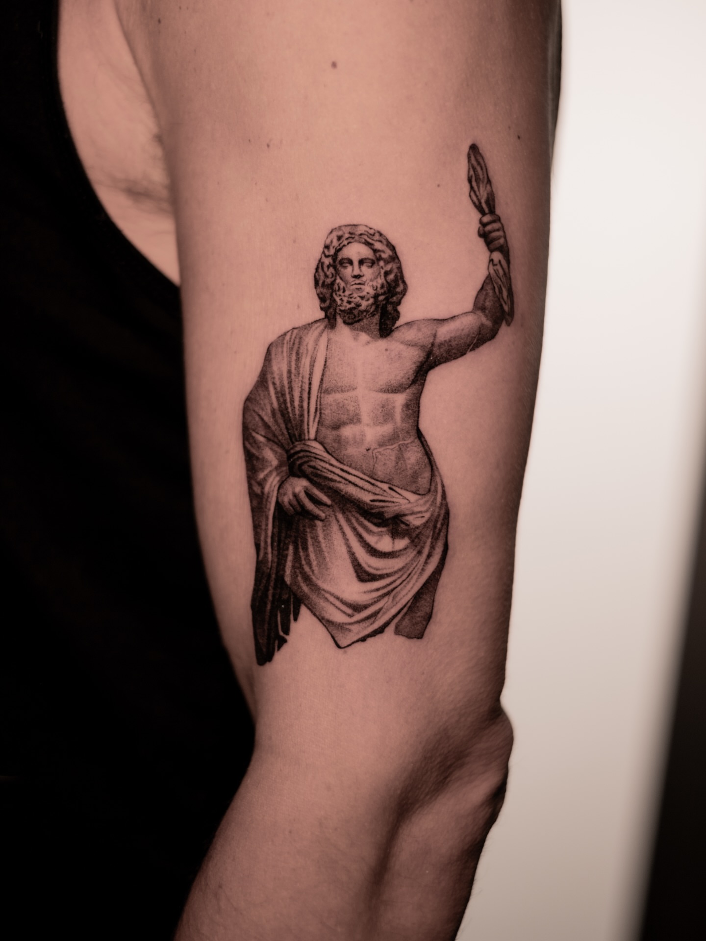 Statue of god black and grey tattoo on the forearm by Mark D, Los Angeles, California