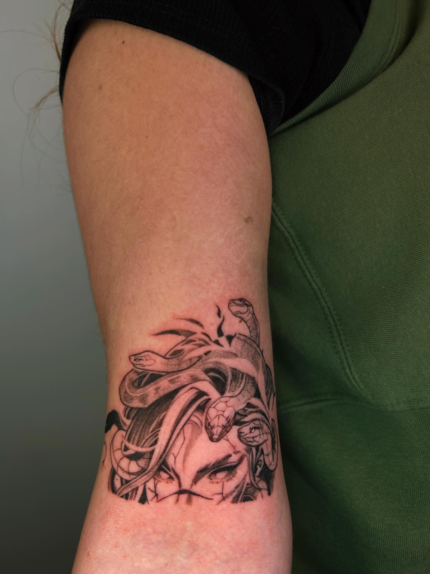 Snake and woman realism tattoo on the forearm by J